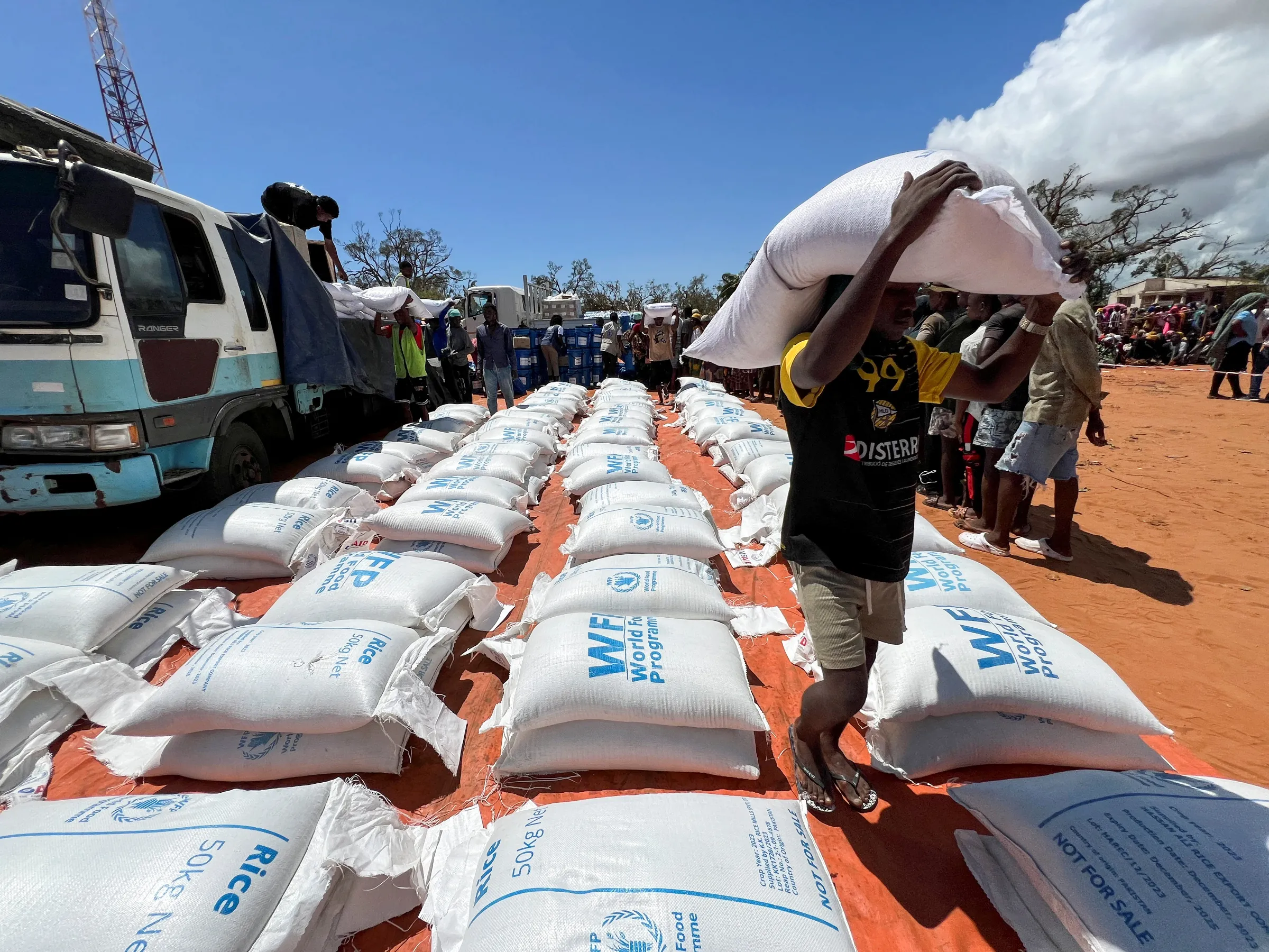 Volunteers distribute supplies from the World Food Programme to residents after cyclone Chido in Pemba, Mozambique, December 18, 2024. REUTERS/Shafiek Tassiem