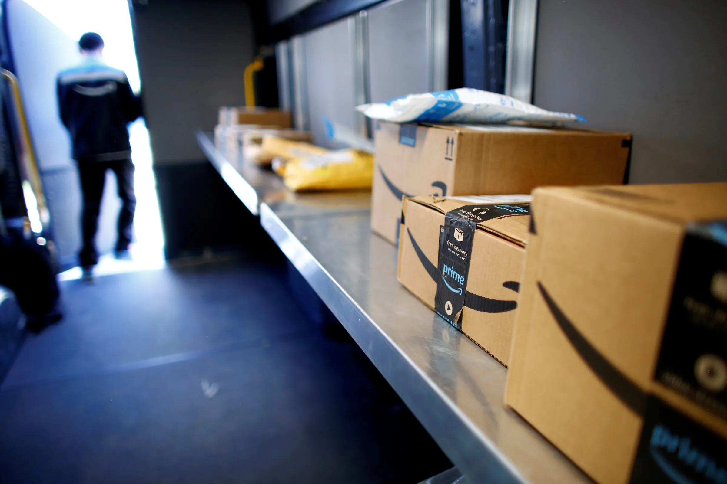 An Amazon worker delivers packages in Denver, Colorado, U.S., April 22, 2020. REUTERS/Kevin Mohatt