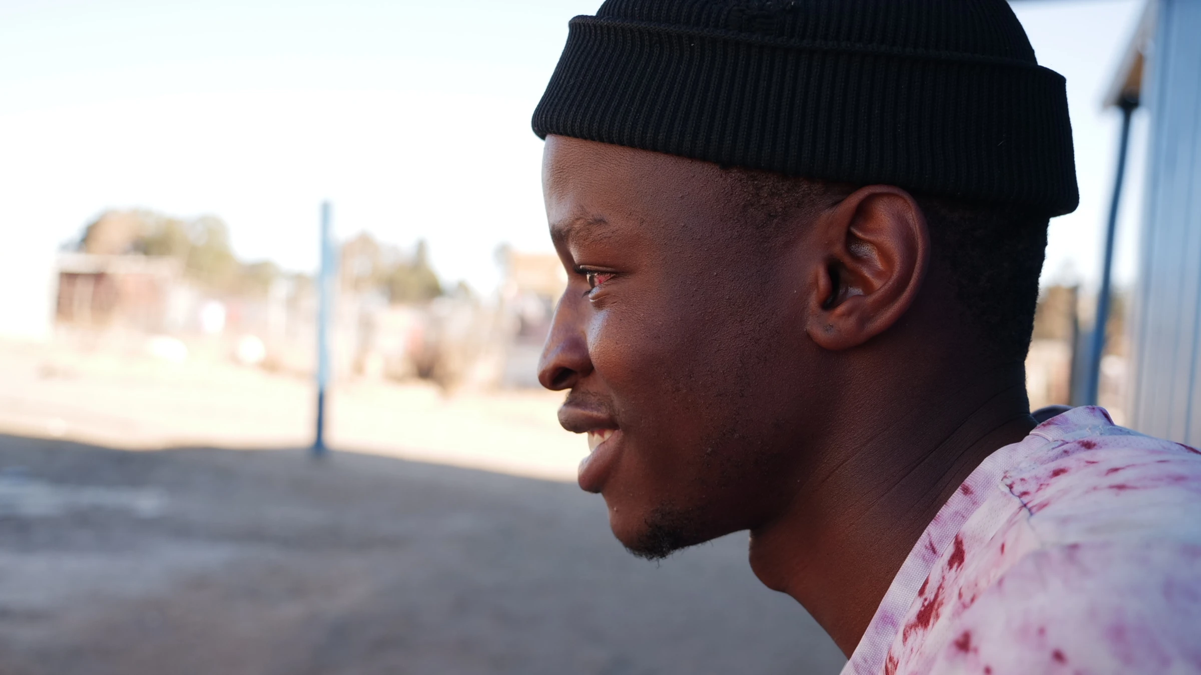 Lindokuhle Malaza, a 23-year-old trained to install the solar bricks, sits on the pavement near his house in Nomzamo, South Africa, July 10, 2025. Thomson Reuters Foundation/Kim Harrisberg