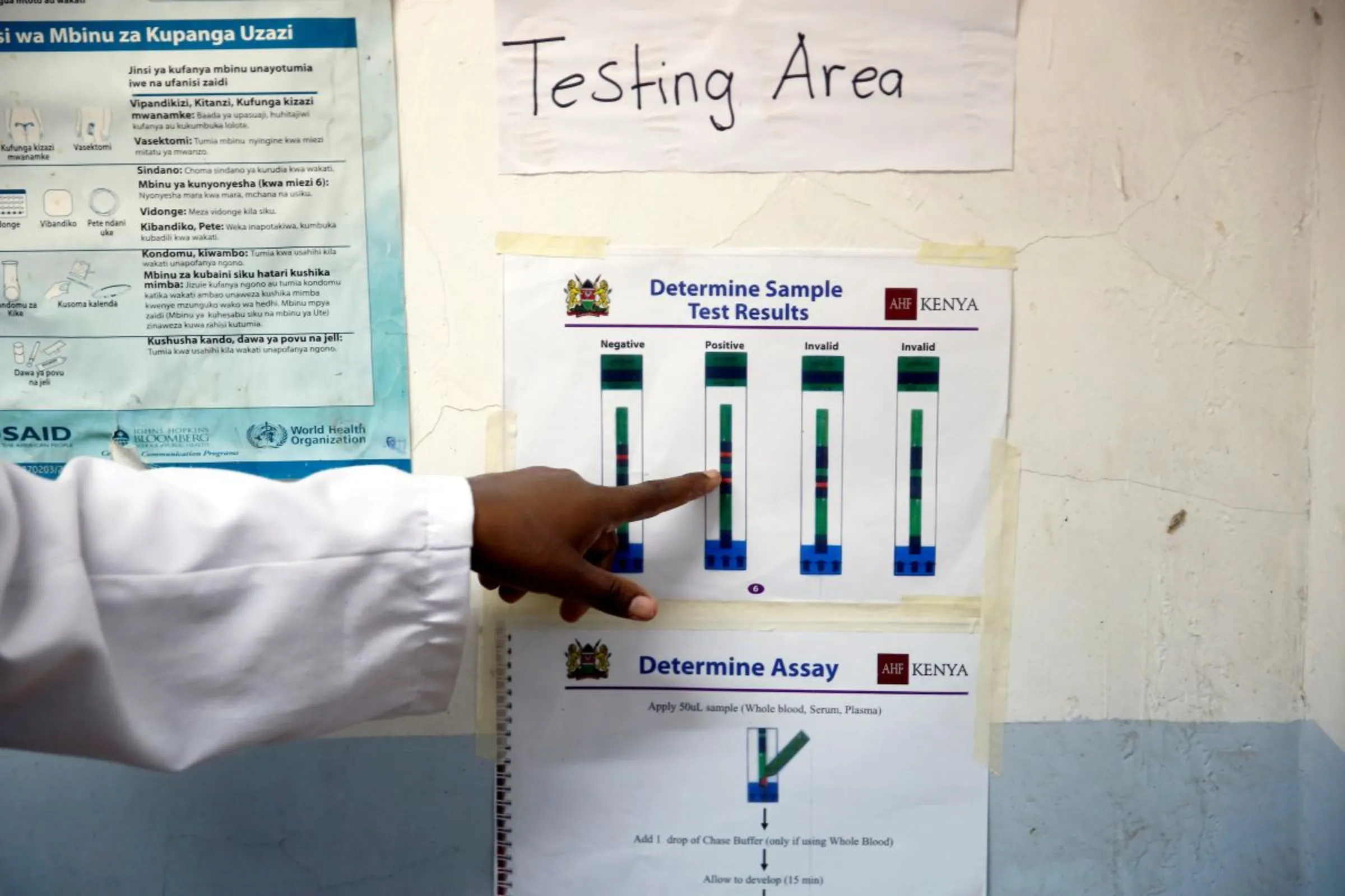 Julia Waruguru, an HIV adherence counsellor points to a poster of test results to a woman who was tested for HIV at the IOM treatment centre in Eastleigh, Nairobi, Kenya, November 29, 2018. Picture taken November 29, 2018 REUTERS/Baz Ratner
