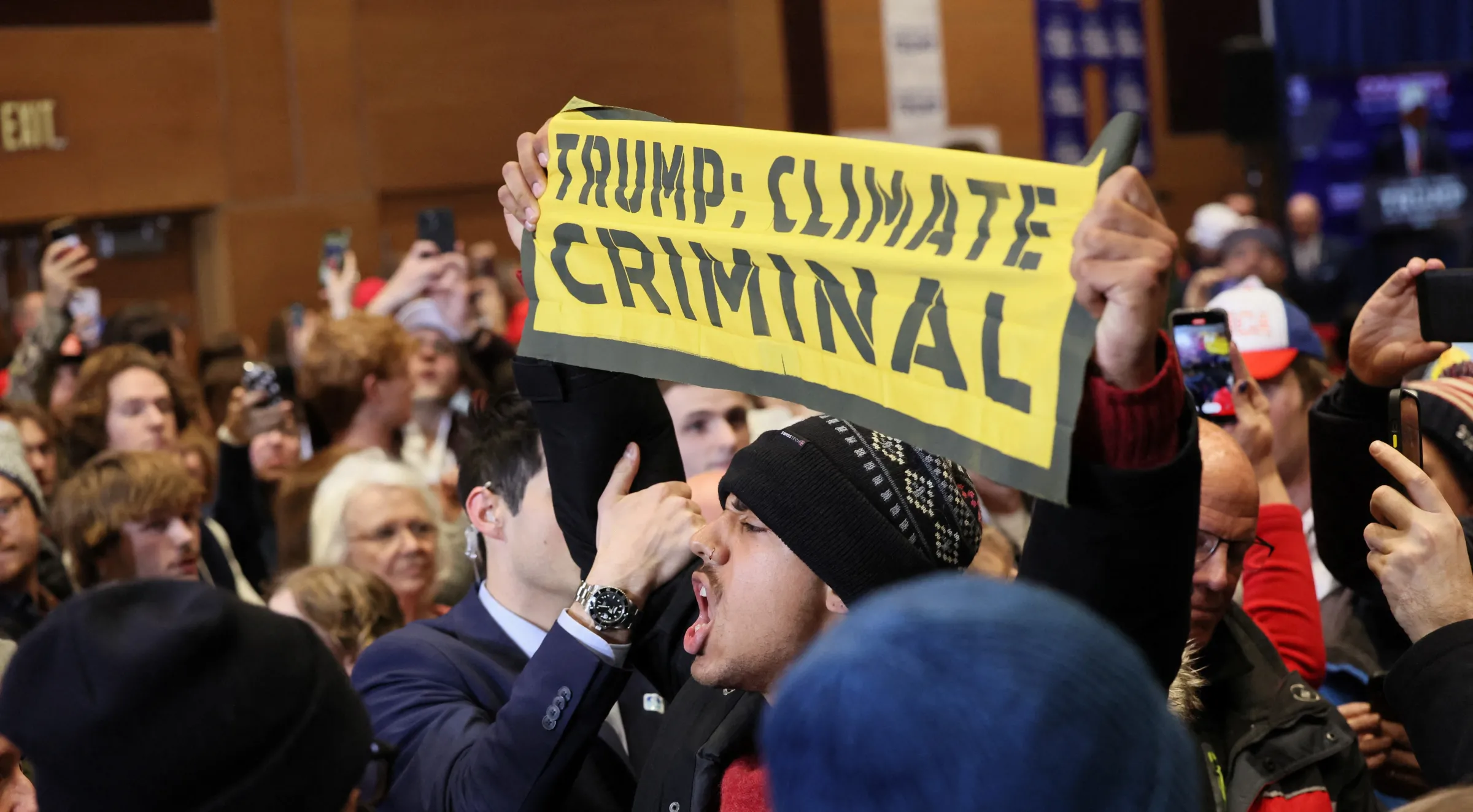 A climate protester interrupts the campaign event of Former U.S. President and Republican presidential candidate Donald Trump, in Indianola, Iowa, U.S., January 14, 2024. REUTERS/Brendan McDermid