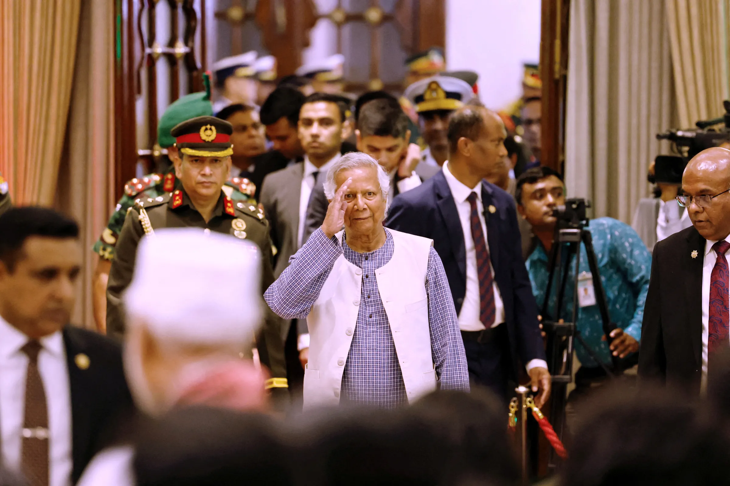 Nobel laureate Muhammad Yunus salutes to the attendees upon arrival at the Bangabhaban to take oath as the head of the interim government, in Dhaka, Bangladesh, August 8, 2024. REUTERS/Mohammad Ponir Hossain
