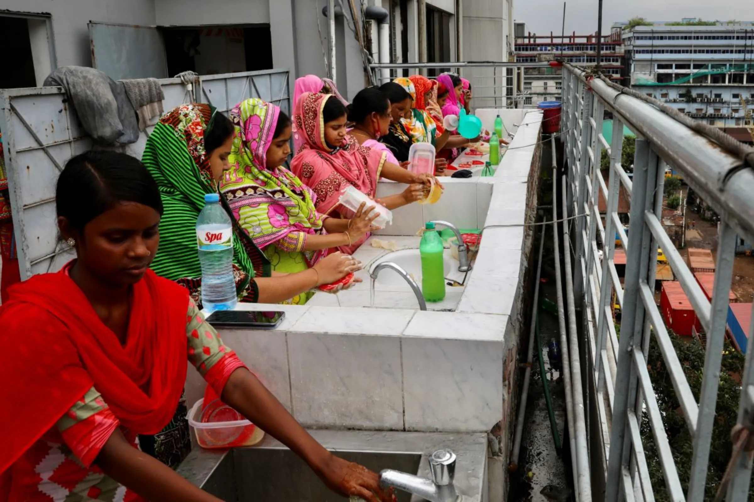 Employees wash their hands before lunch at The Civil Engineering Limited garment factory in Dhaka, Bangladesh, August 17, 2021. REUTERS/Mohammad Ponir Hossain