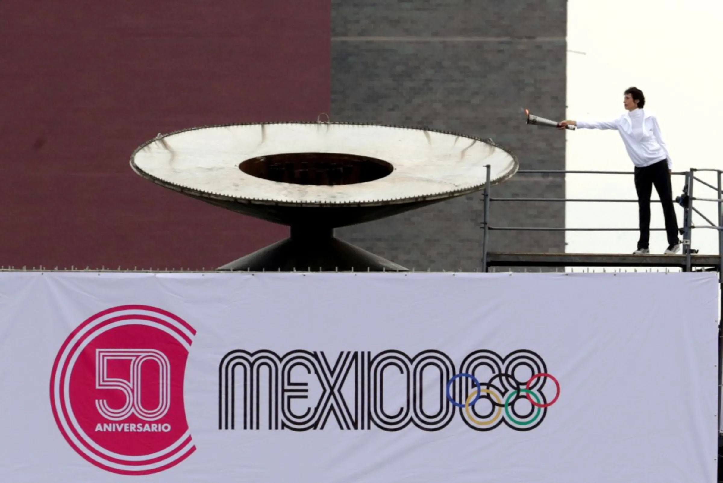 Enriqueta Basilio holds the Olympic torch before lighting the cauldron at the University Olympic Stadium to mark the 50th Anniversary of the 1968 Olympic Games, in Mexico City, Mexico October 12, 2018. REUTERS/Henry Romero