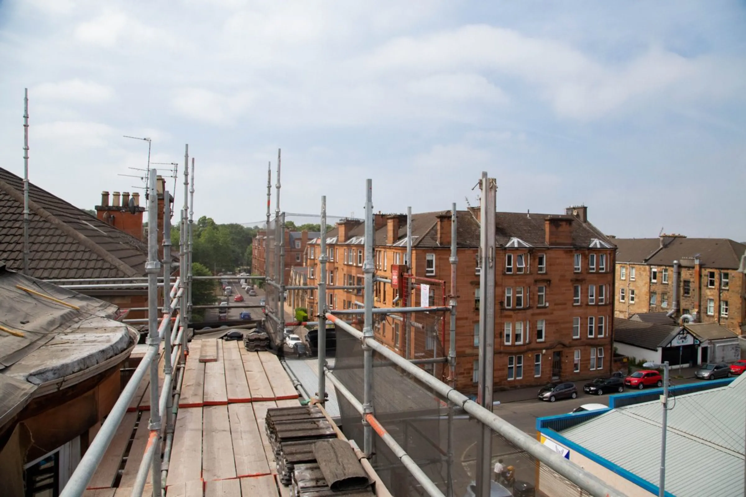 Blocks of red and blonde sandstone tenements are pictured from a scaffolding in Glasgow, United Kingdom, July 23, 2021. Tenement flats built in the 19th and 20th centuries are a key part of Glasgow's architectural heritage, but are hard to bring up to energy efficiency standards