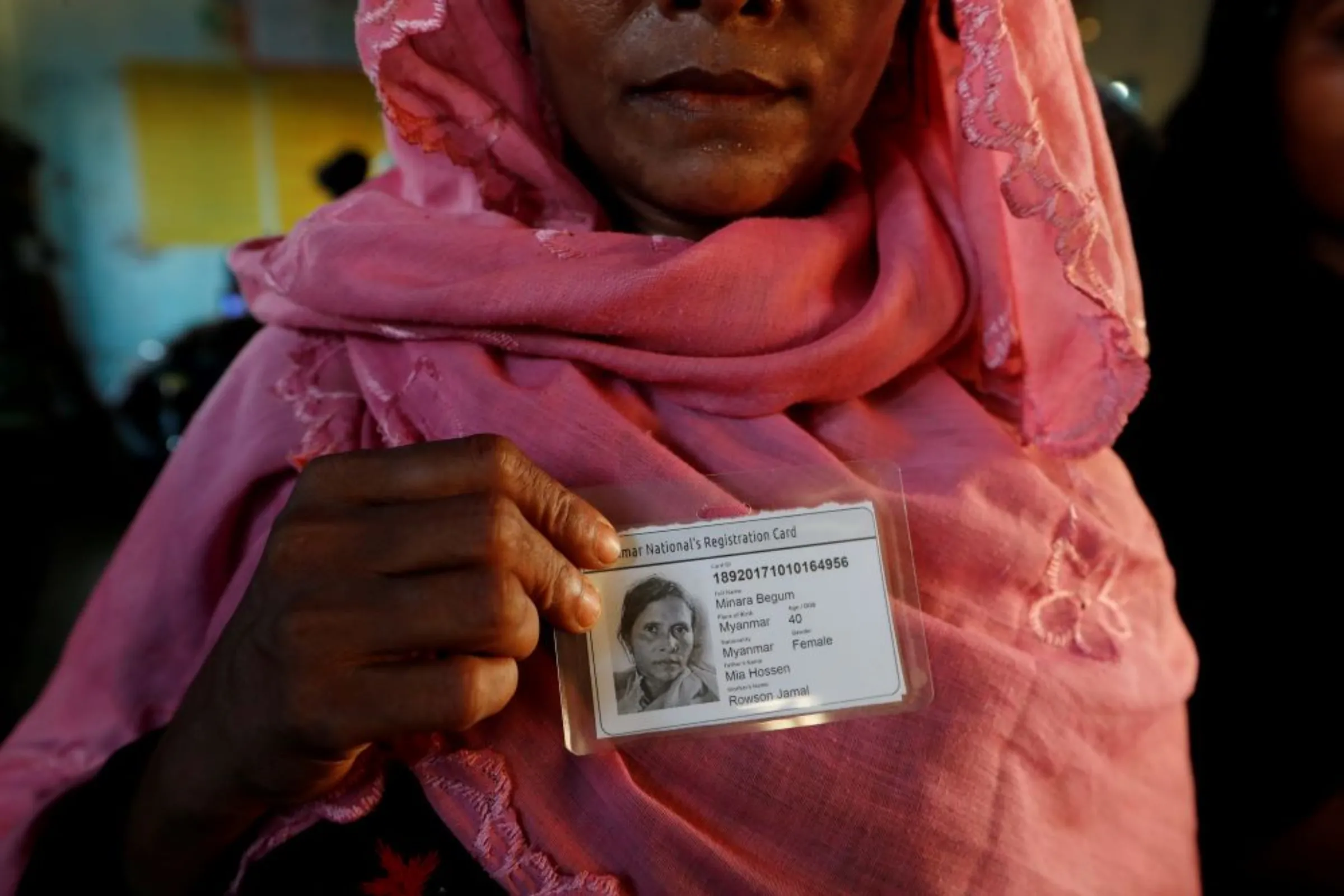 Rohingya refugee woman poses after receiving an ID card from Bangladesh army in a camp near Cox's Bazar, Bangladesh October 10, 2017