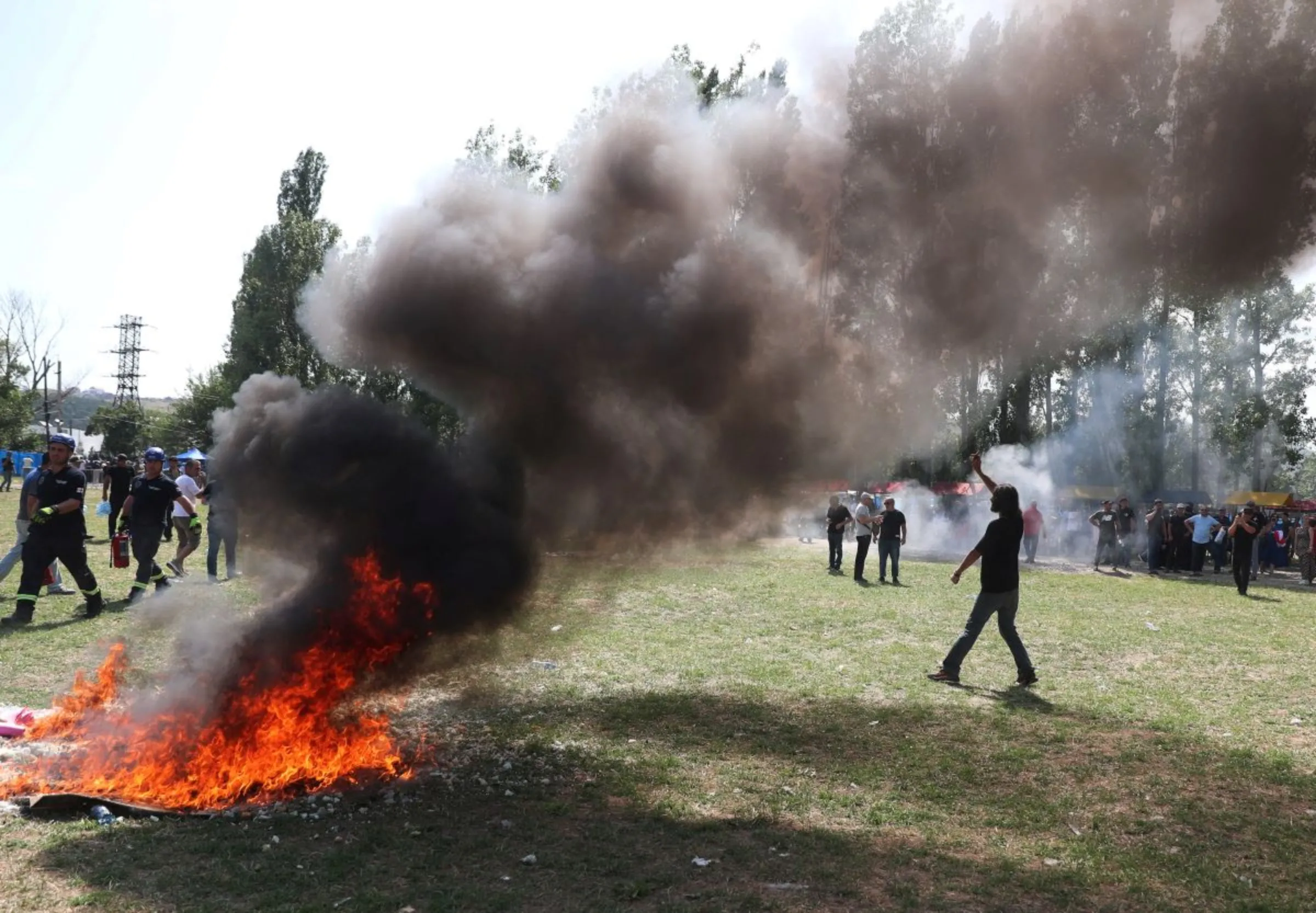 Anti-LGBTQ protesters make a bonfire in area designated for the Tbilisi Pride Fest, in Tbilisi, Georgia July 8, 2023. REUTERS/Irakli Gedenidze