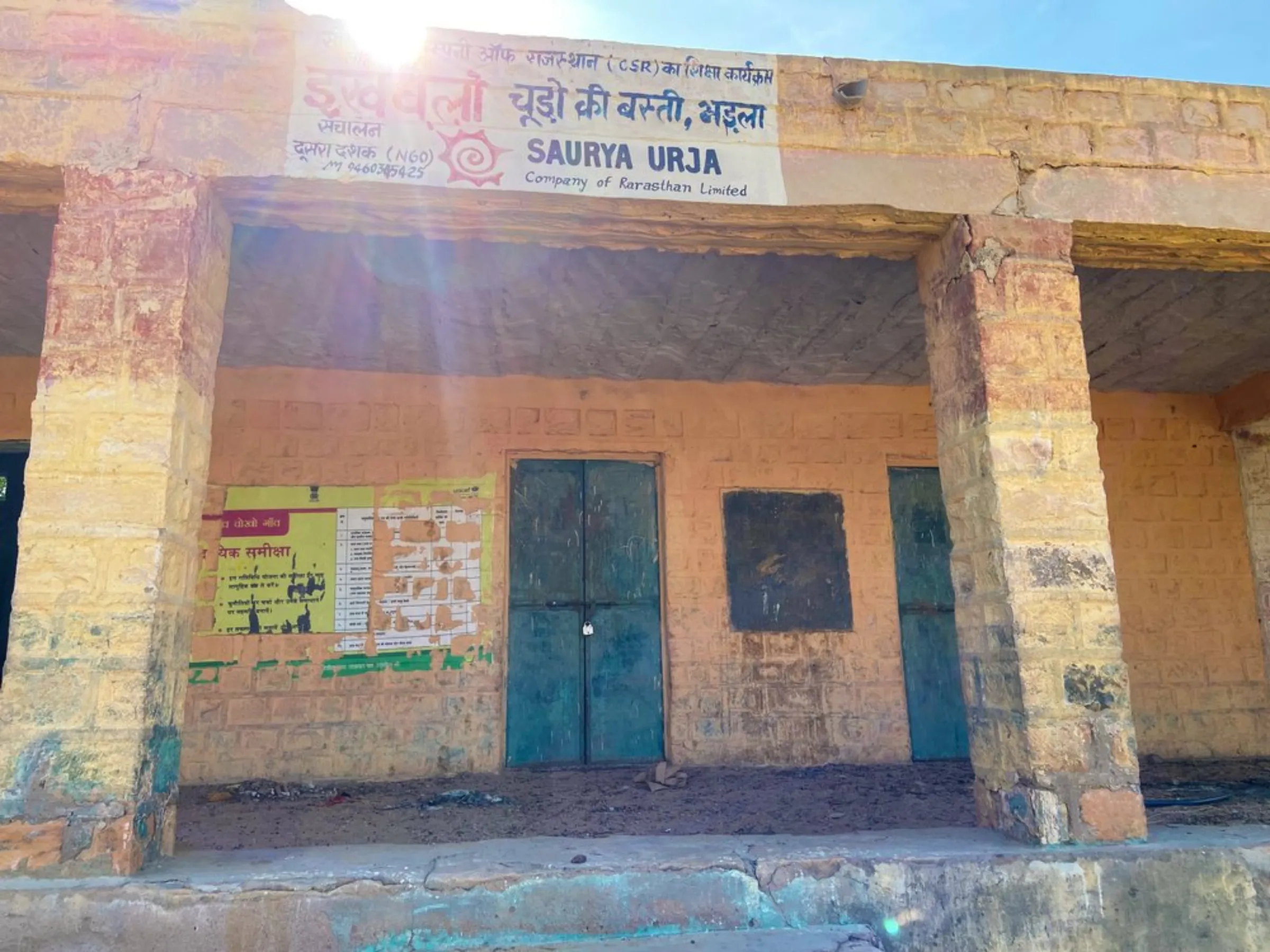 A locked classroom at the village school in Bhadla, with the name of the solar company that funded its revival still painted on the wall, Rajasthan, India, December 11, 2021