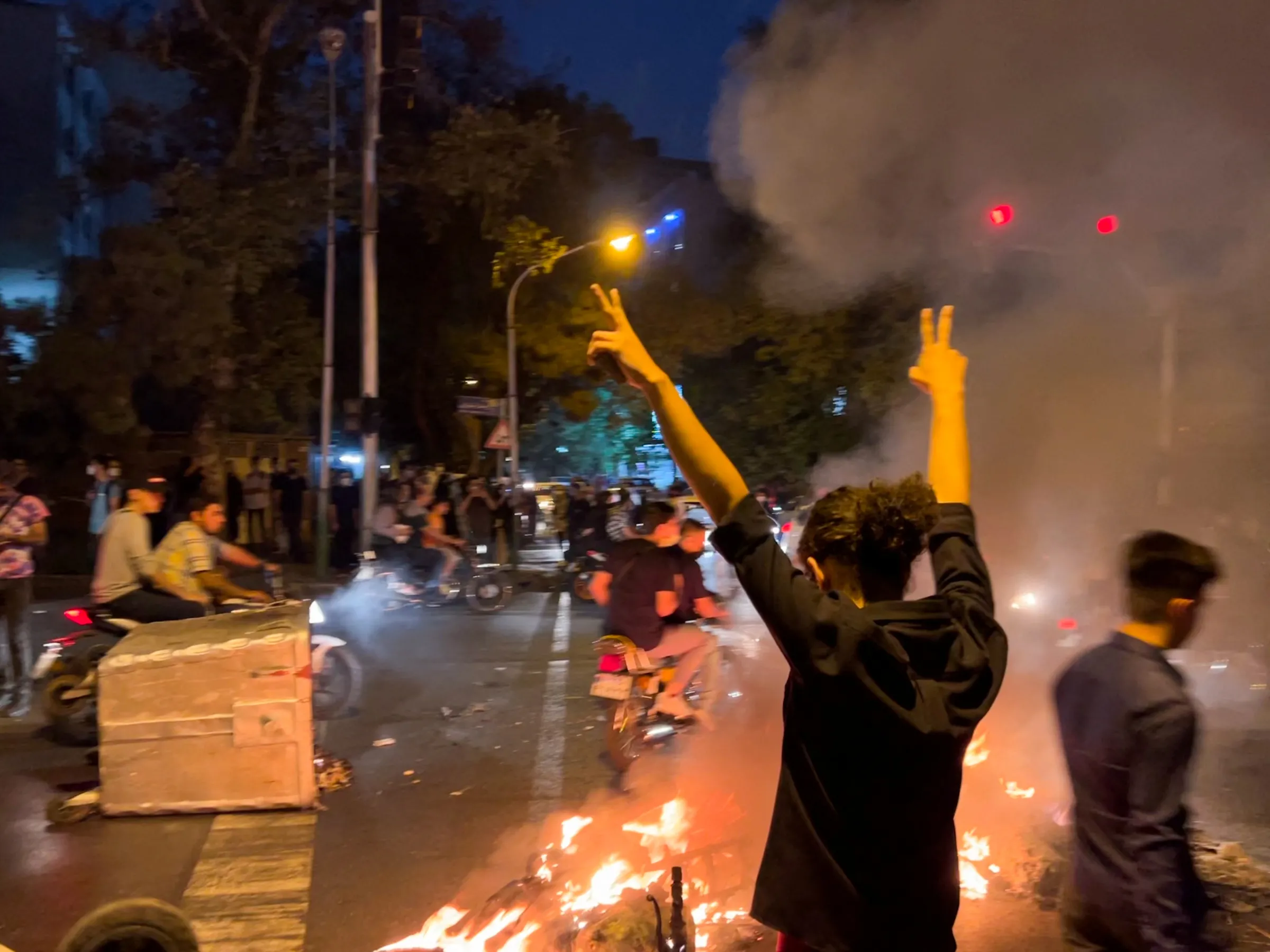 A man gestures during a protest over the death of Mahsa Amini, a woman who died after being arrested by the Islamic republic's 'morality police', in Tehran, Iran September 19, 2022. WANA (West Asia News Agency) via REUTERS