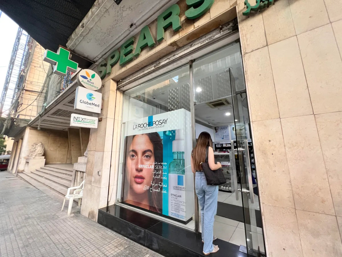 A woman enters a pharmacy in Beirut, Lebanon, 20 Sept 2022