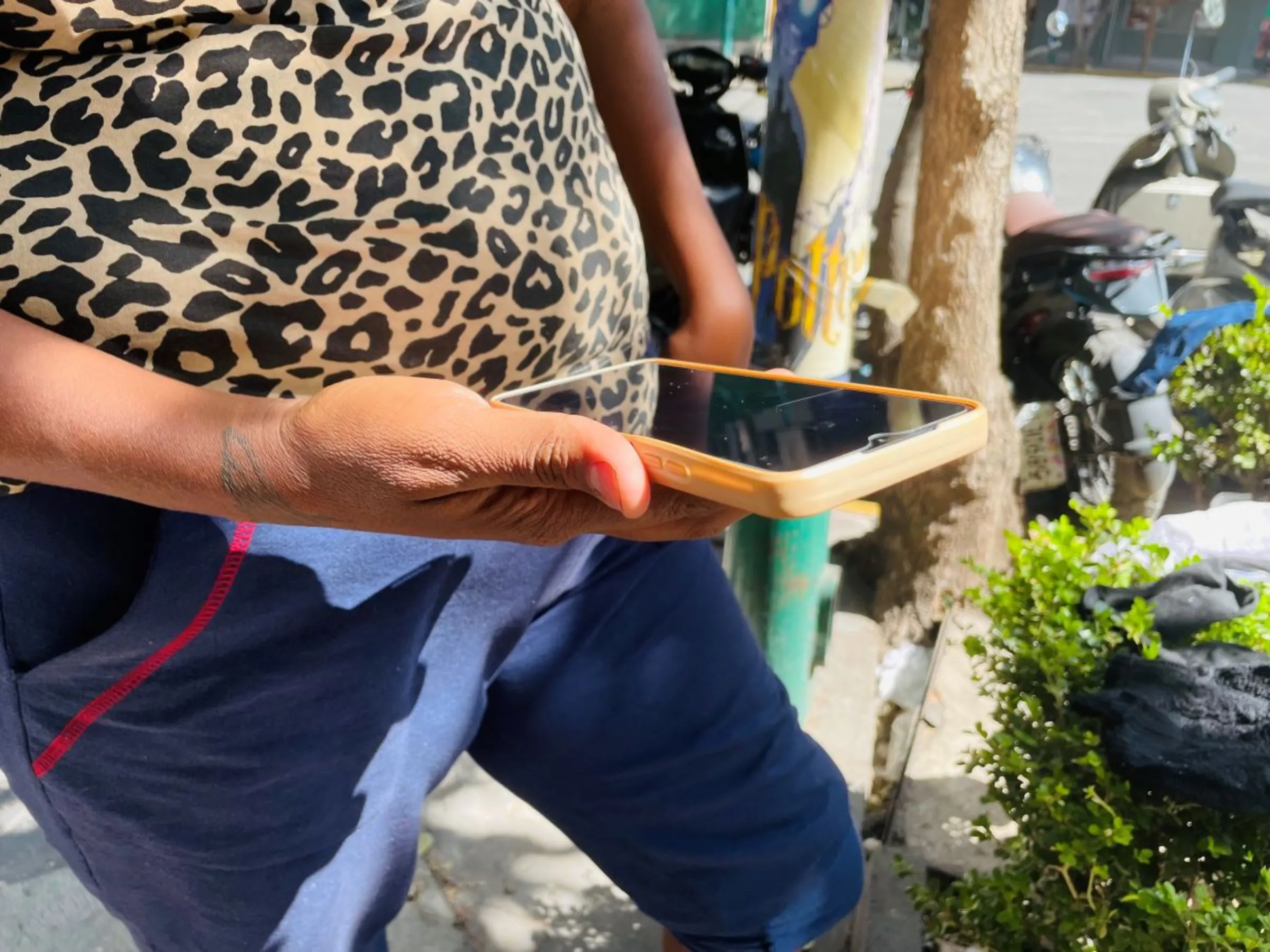 Nicaraguan migrant Marina Pérez poses with her phone at a migrant camp in Mexico City, Mexico. February 12, 2024. Thomson Reuters Foundation/Diana Baptista