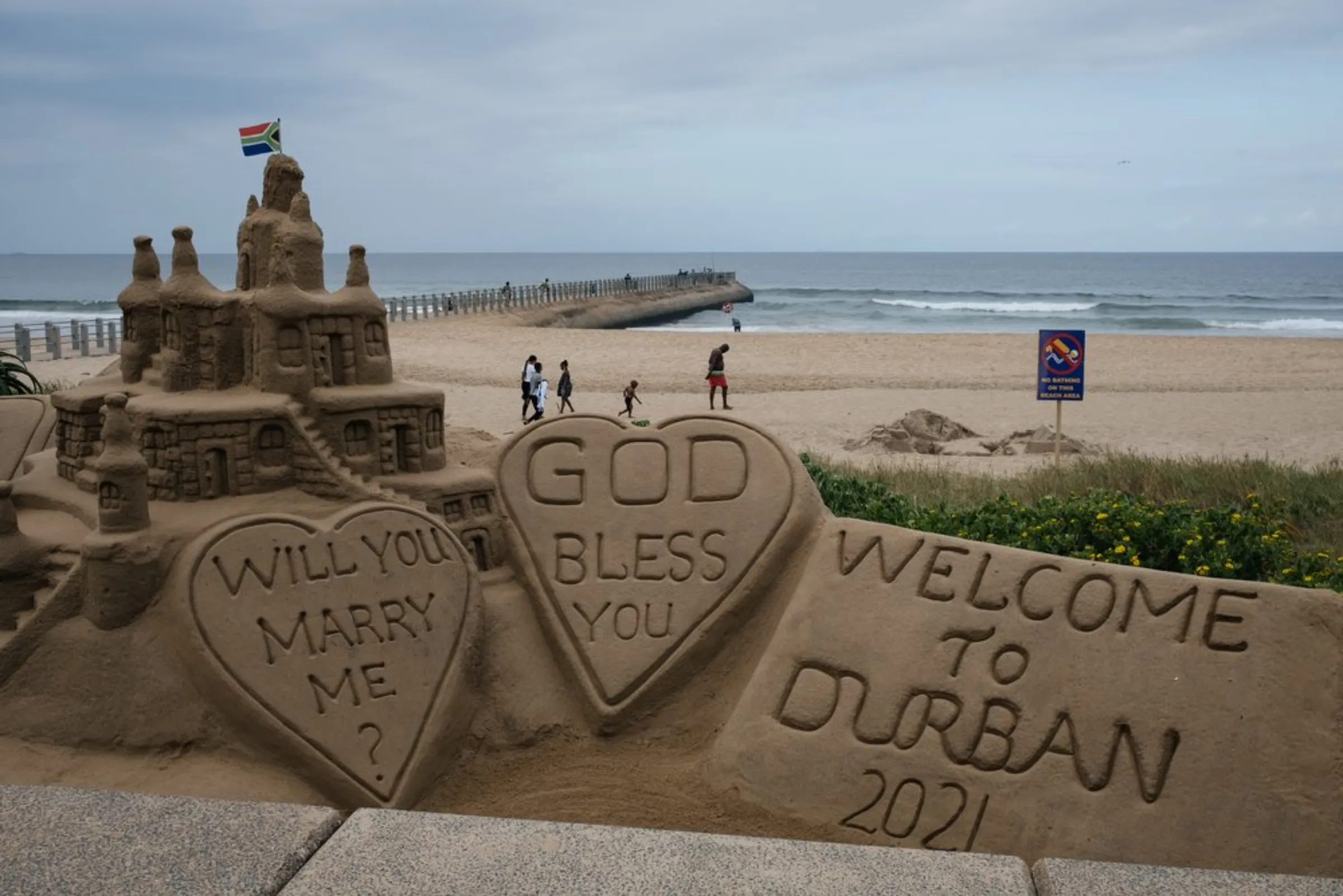 A sand sculpture stands along Durban's beachfront promenade, the city's main attraction for tourists and locals alike, April 1, 2021. Rising sea-levels as a result of climate change threaten the iconic stretch of beach