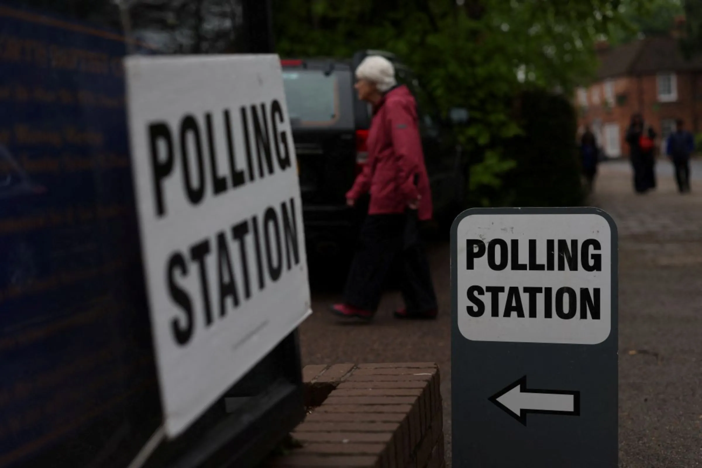 A person enters a polling station in Rickmansworth, Britain, May 2, 2024. REUTERS/Suzanne Plunkett