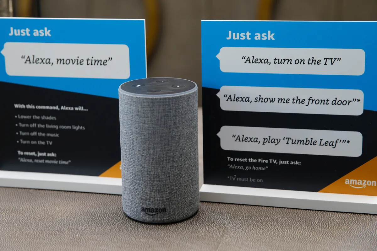 Prompts on how to use Amazon's Alexa personal assistant are placed next to an Alexa device