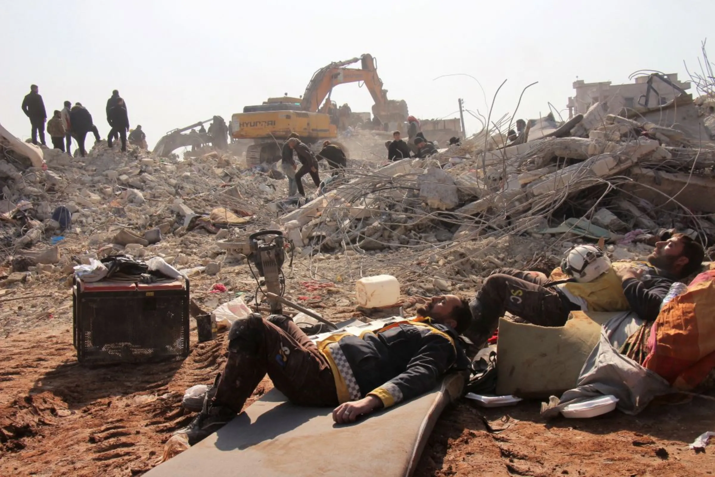 White Helmets members rest on day five of the rescue operations after a massive earthquake in Jandaris, Syria February 10, 2023 in this image obtained from social media. White Helmets via REUTERS