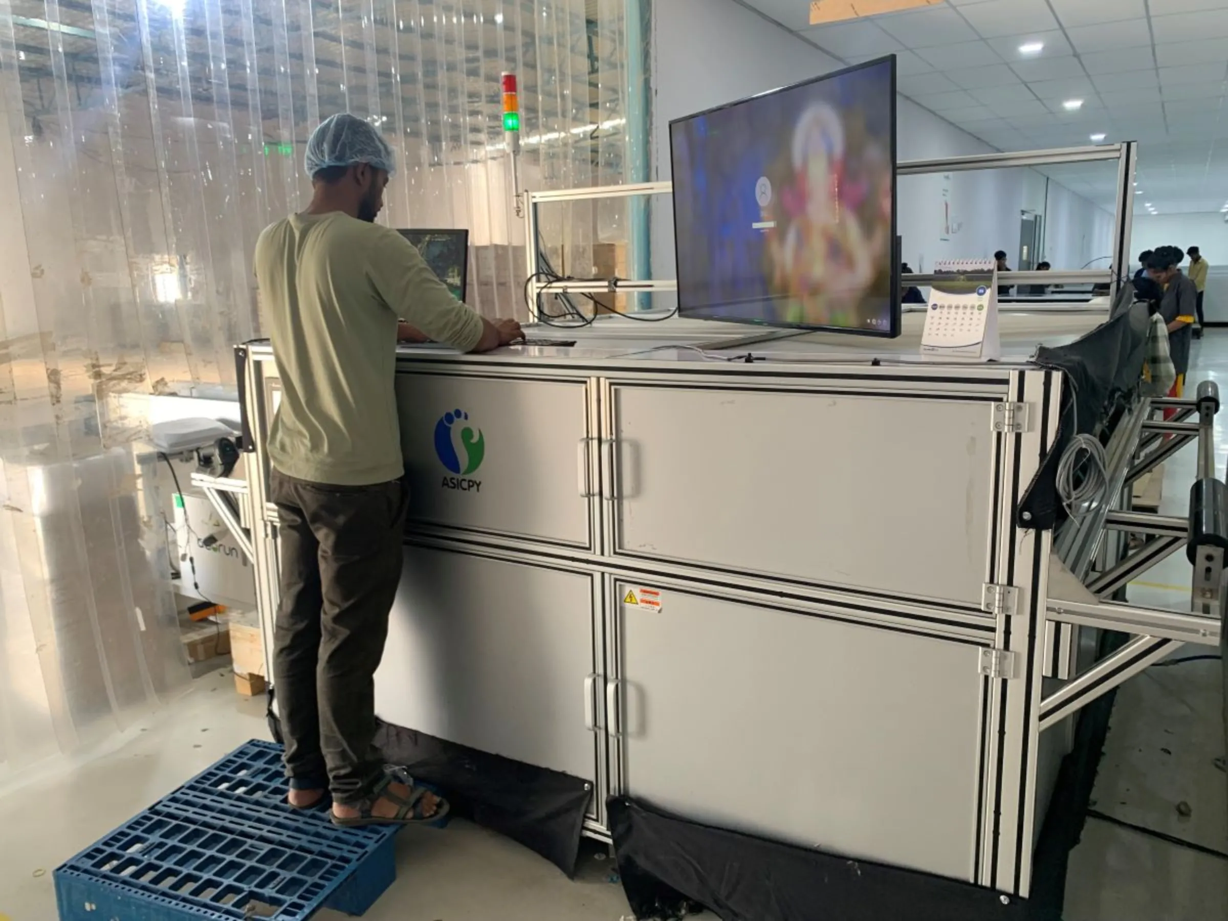 A worker checking solar panels for manufacturing defects at Sunbond Energy Pvt Ltd in Mitana in western Gujarat, India, May 29, 2023. Thomson Reuters Foundation/Anuradha Nagaraj