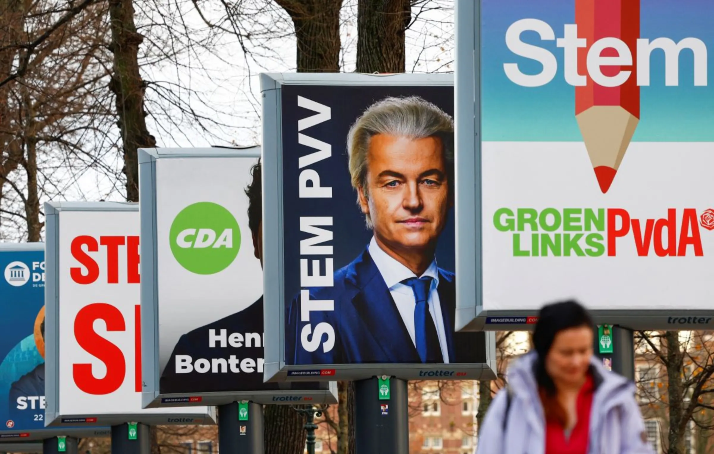 A person walks past election boards ahead of the Dutch parliamentary election in The Hague, Netherlands, November 21, 2023. REUTERS/Piroschka Van De Wouw