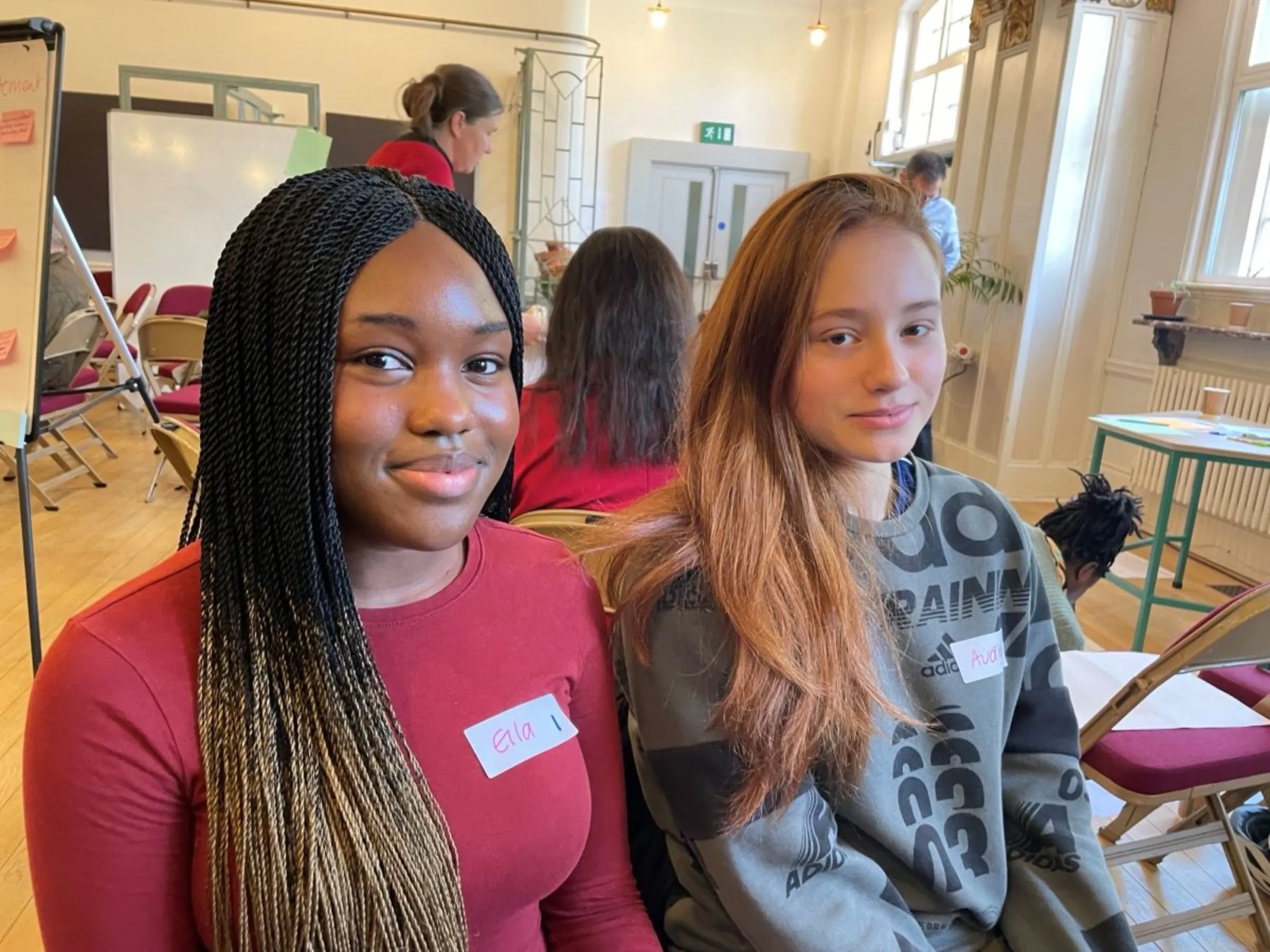 High school student Ella Kone (left) of Putney and another young participant take part in the London borough of Wandsworth’s citizen’s assembly on air quality, April 28, 2023. Thomson Reuters Foundation/Laurie Goering