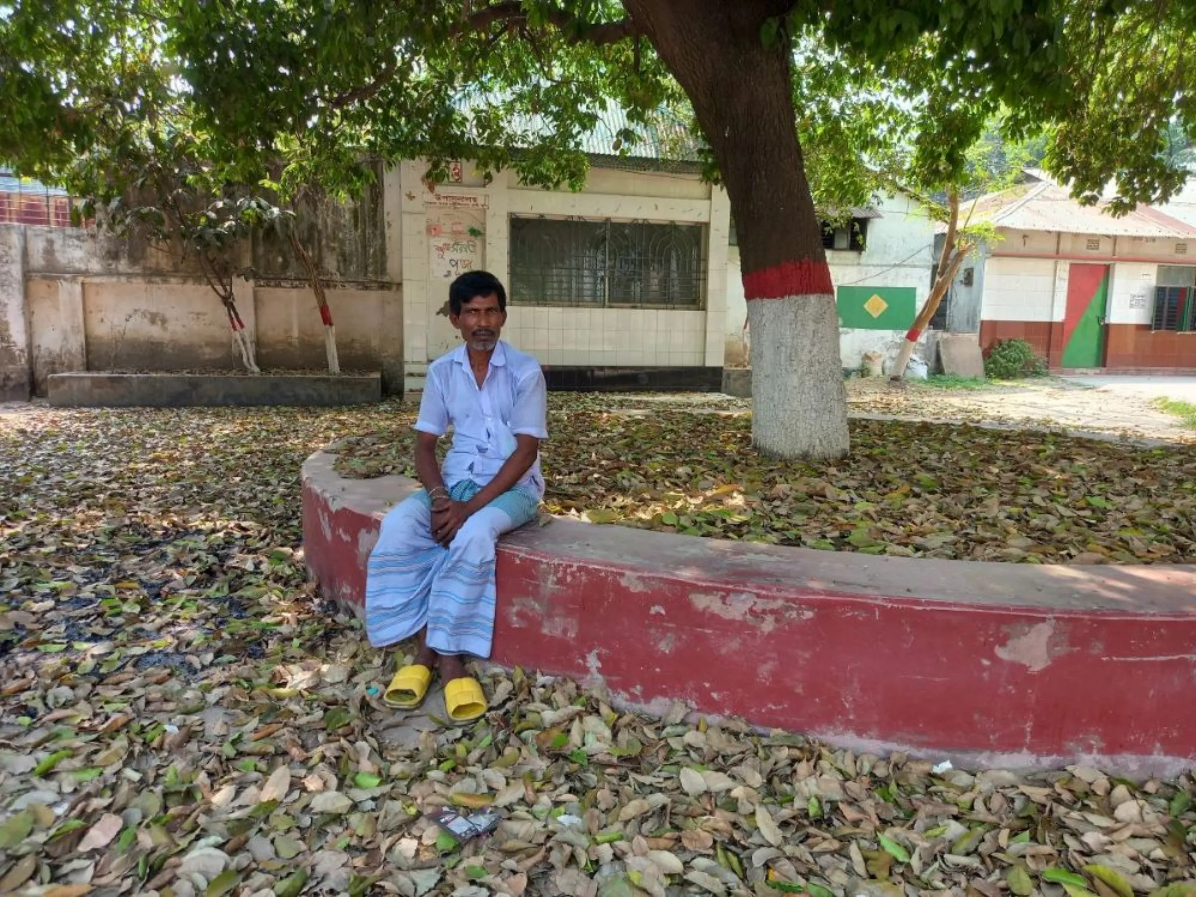 Subal Moni Rishi, 53, a night guard at a local school, sits for a photo in Savar, Bangladesh, April, 17, 2023. Rishi helped hand over the remains of the Rana Plaza victims to their families, and still gets vivid flashbacks of the 2013 tragedy