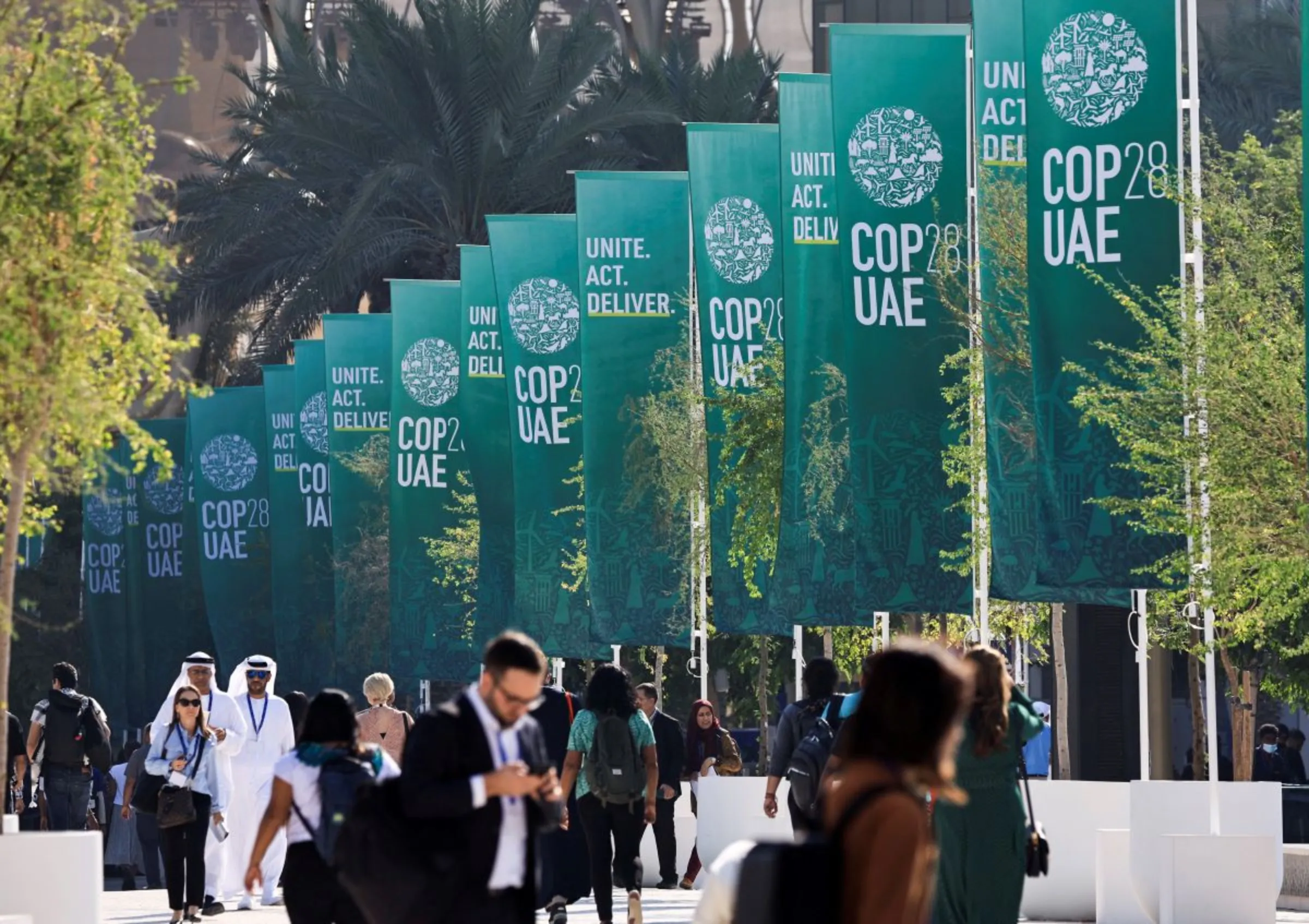 Delegates walk at the United Nations Climate Change Conference COP28 in Dubai, United Arab Emirates, December 8, 2023