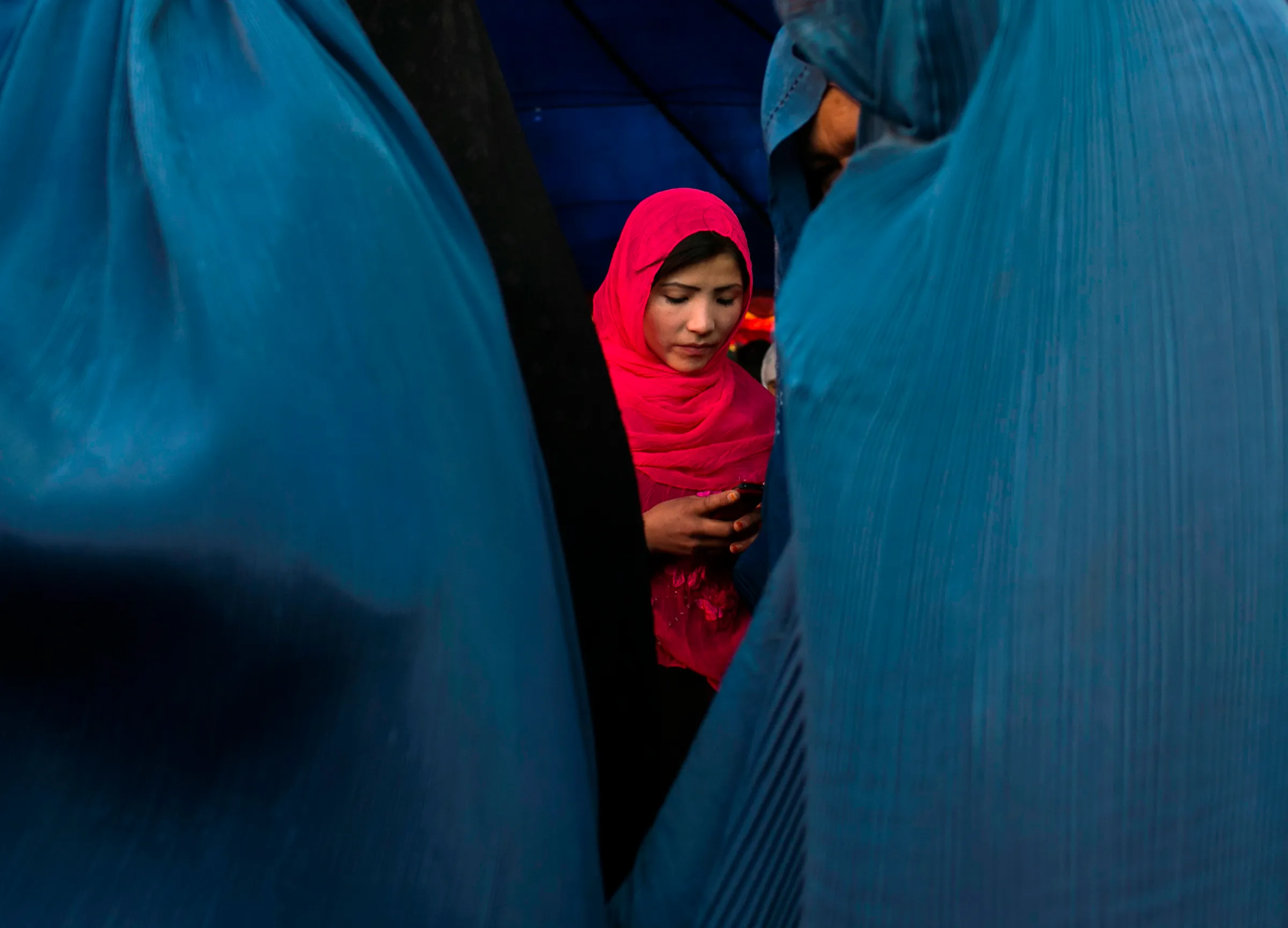 An Afghan woman holds her phone in Kabul June 8, 2014. 
REUTERS/Ahmad Masood