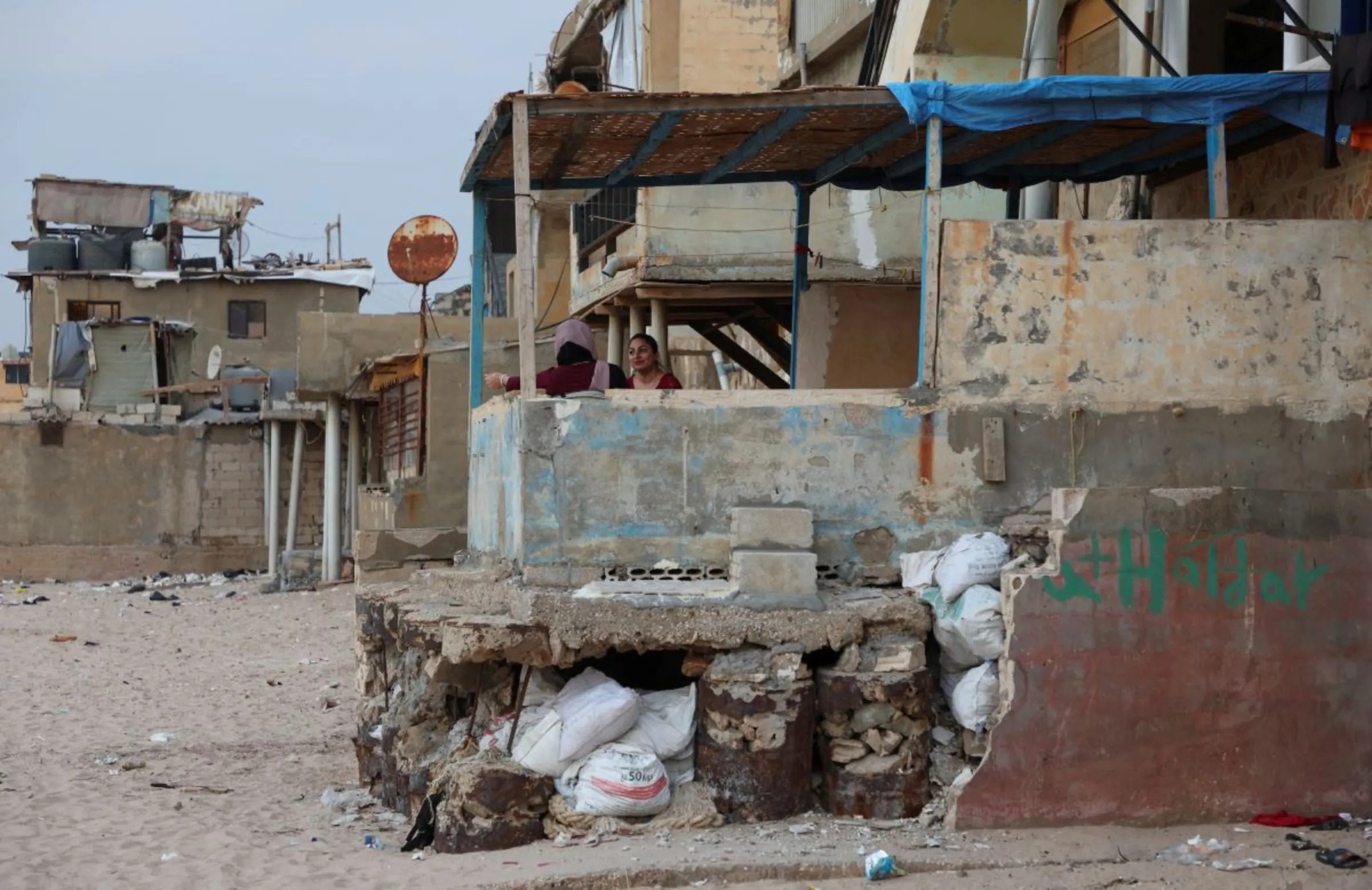 Women sit on a balcony of a house in Beirut's southern suburb of Ouzai, Lebanon November 15, 2022