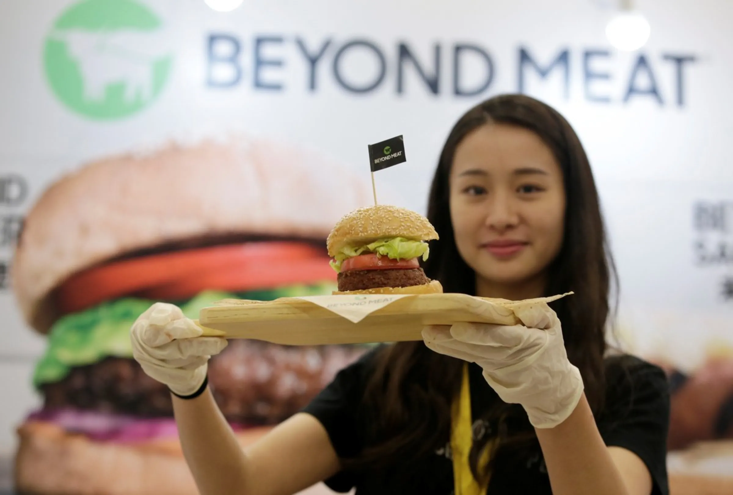 A staff member displays a burger with a Beyond Meat plant-based patty at VeggieWorld fair in Beijing, China November 8, 2019.