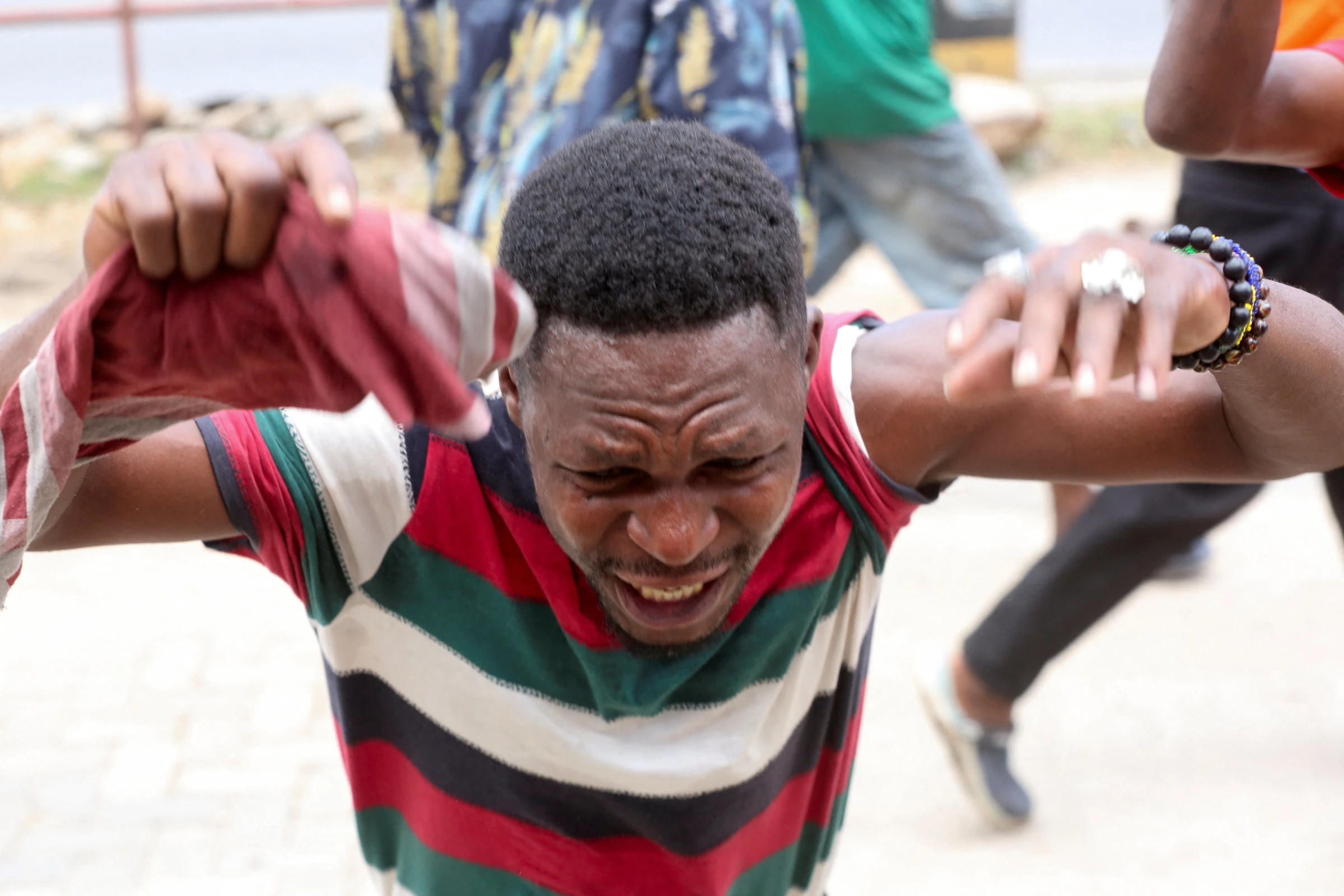 A demonstrator reacts as he participates in violent protests that marred the election following the disqualification of the two leading opposition candidates in Dar es Salaam, Tanzania, October 29, 2025. REUTERS/Onsase Ochando