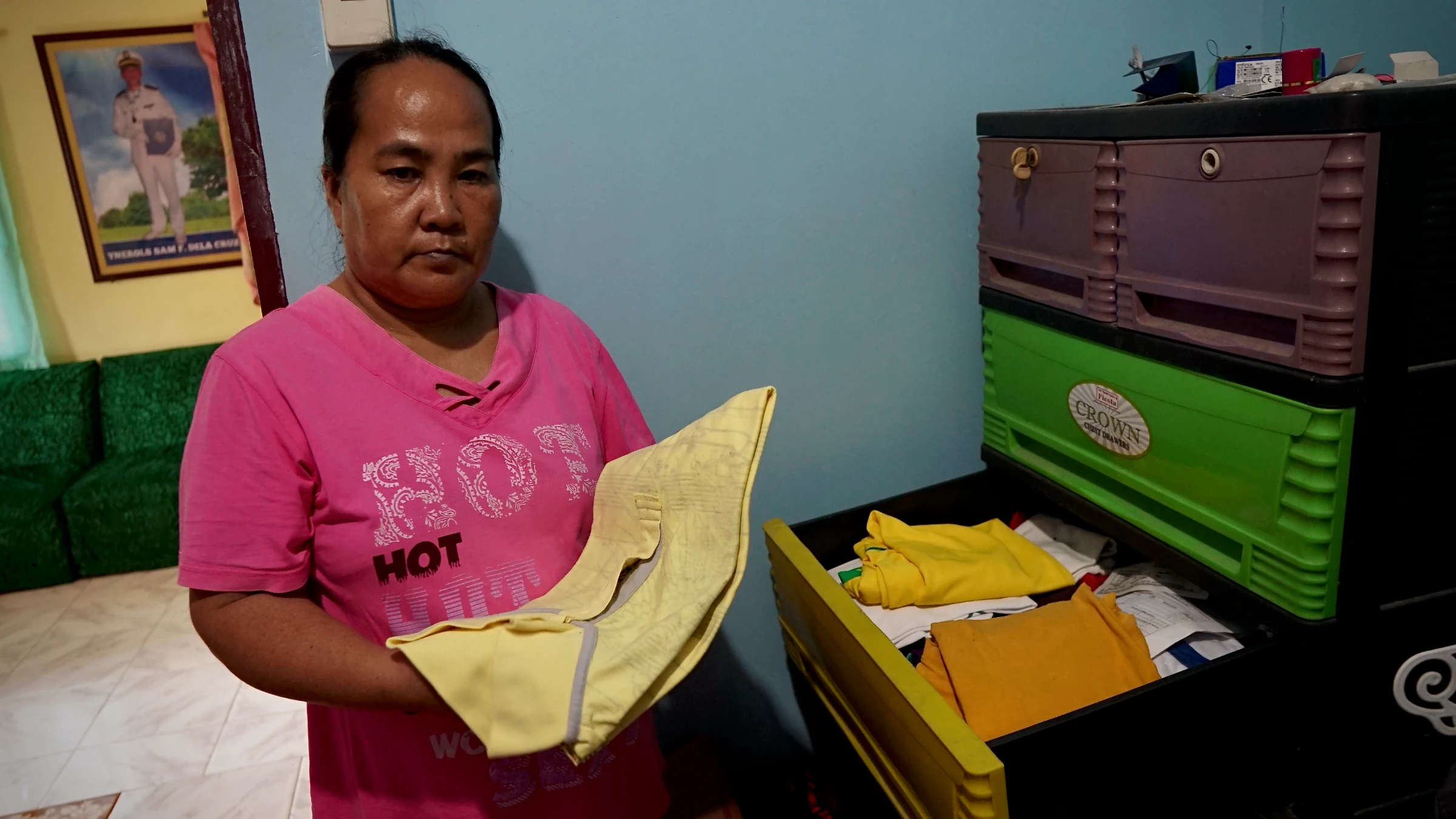 Sam Dela Cruz’s mother, Roselyn, keeps her late son’s clothes. Sultan Kudarat, Philippines, June 4, 2025. Thomson Reuters Foundation/Raizza Bello