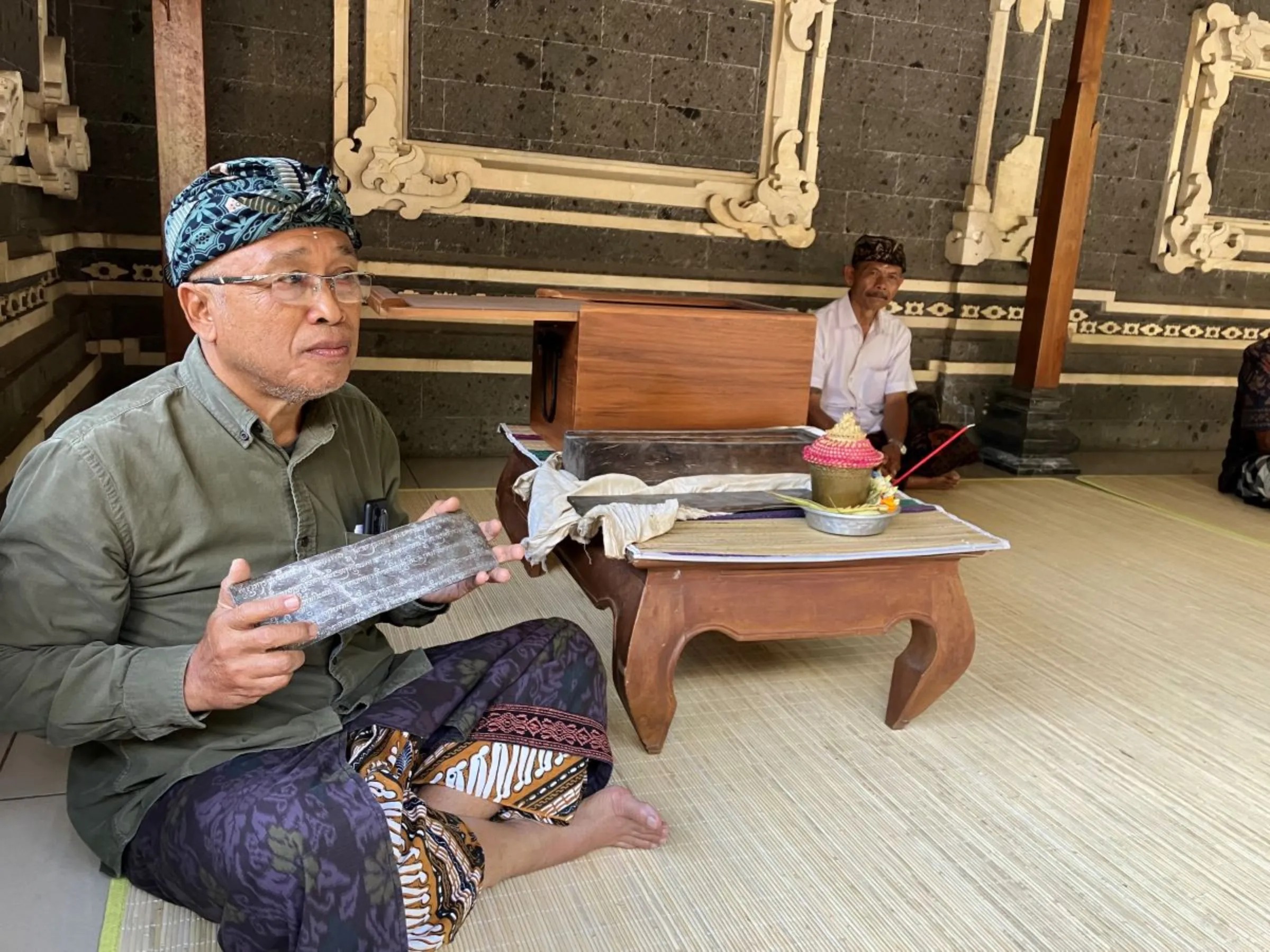 The leader of the the Adat Dalem Tamblingan Indigenous community shows off ancient relics that he says proves his people have a right to be given custodian rights over their lands in northern Bali, Indonesia on Sept 19, 2023. Thomson Reuters Foundation/Michael Taylor