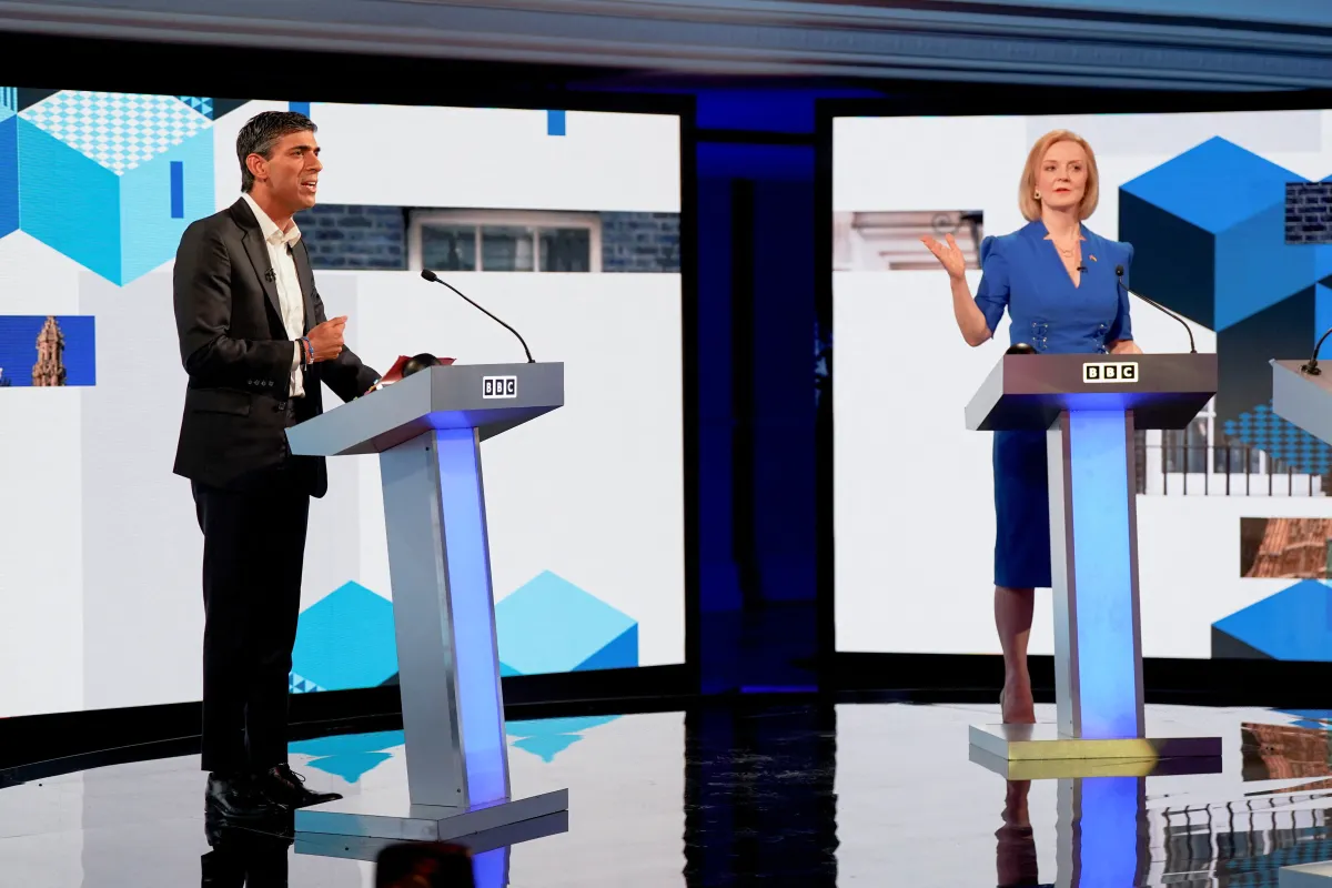 Politicians stand behind podiums in a television studio