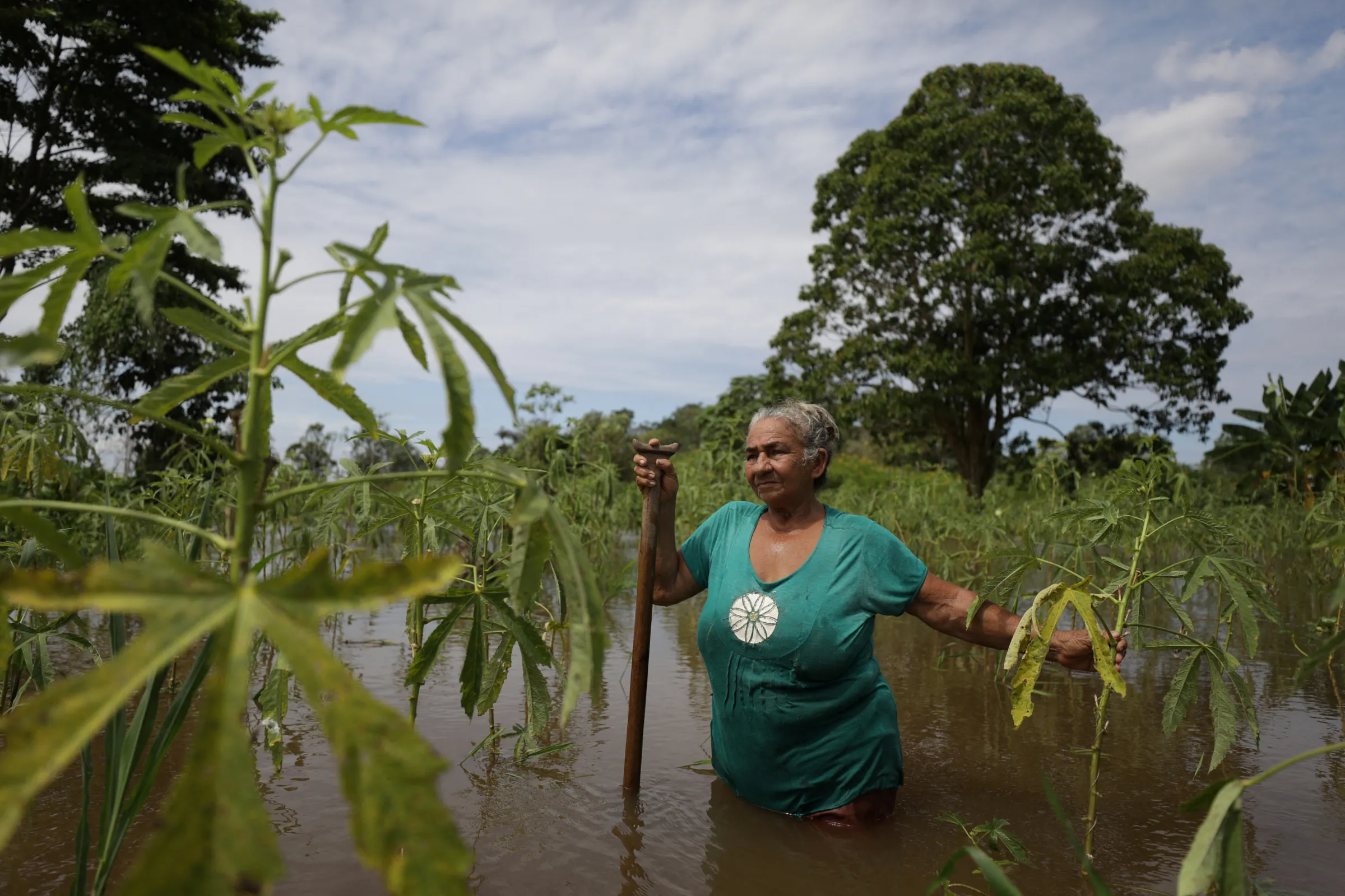 A local farmer stands amidst the flood waters as she observes the damages at her plantation, after several riverside villages were affected by flooding triggered by the rise of the rivers levels in Careiro da Varzea in the Amazonas state, Brazil May 20, 2022. REUTERS/Bruno Kelly