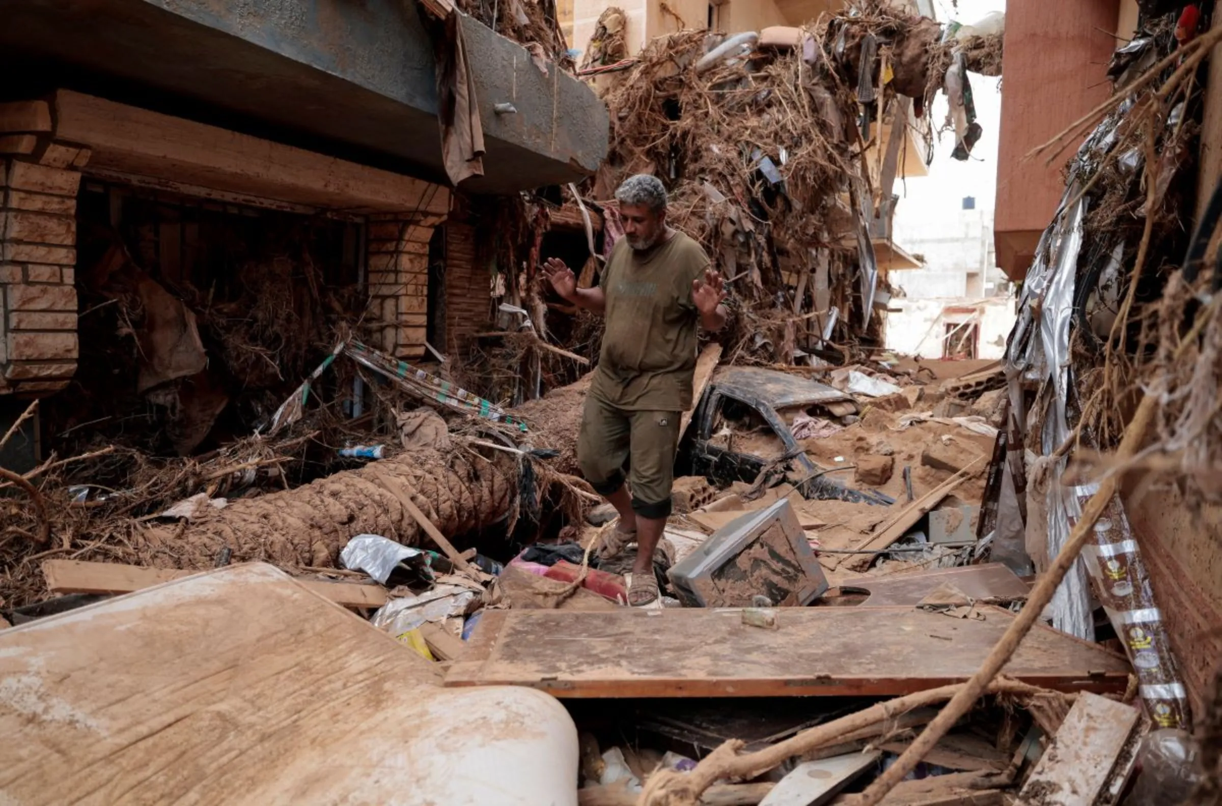 A flood survivor gestures as he walks throughout a street, that was hit by a powerful storm and heavy rainfall, in Derna, Libya September 16, 2023