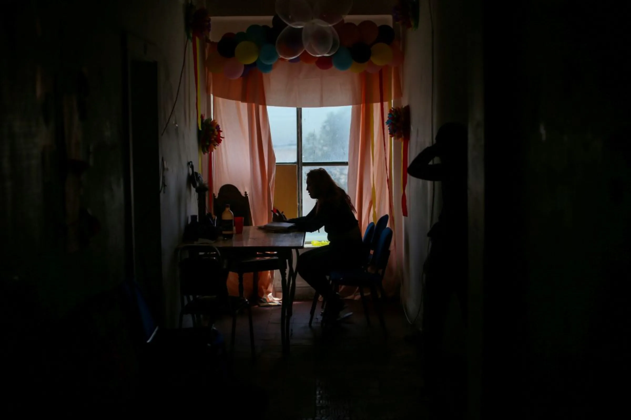 A Central American migrant from the LGBT community is pictured inside an abandoned hotel where she lives temporarily, while expecting to apply for asylum in the U.S., in Ciudad Juarez, Mexico, March 29, 2021. REUTERS/Edgard Garrido