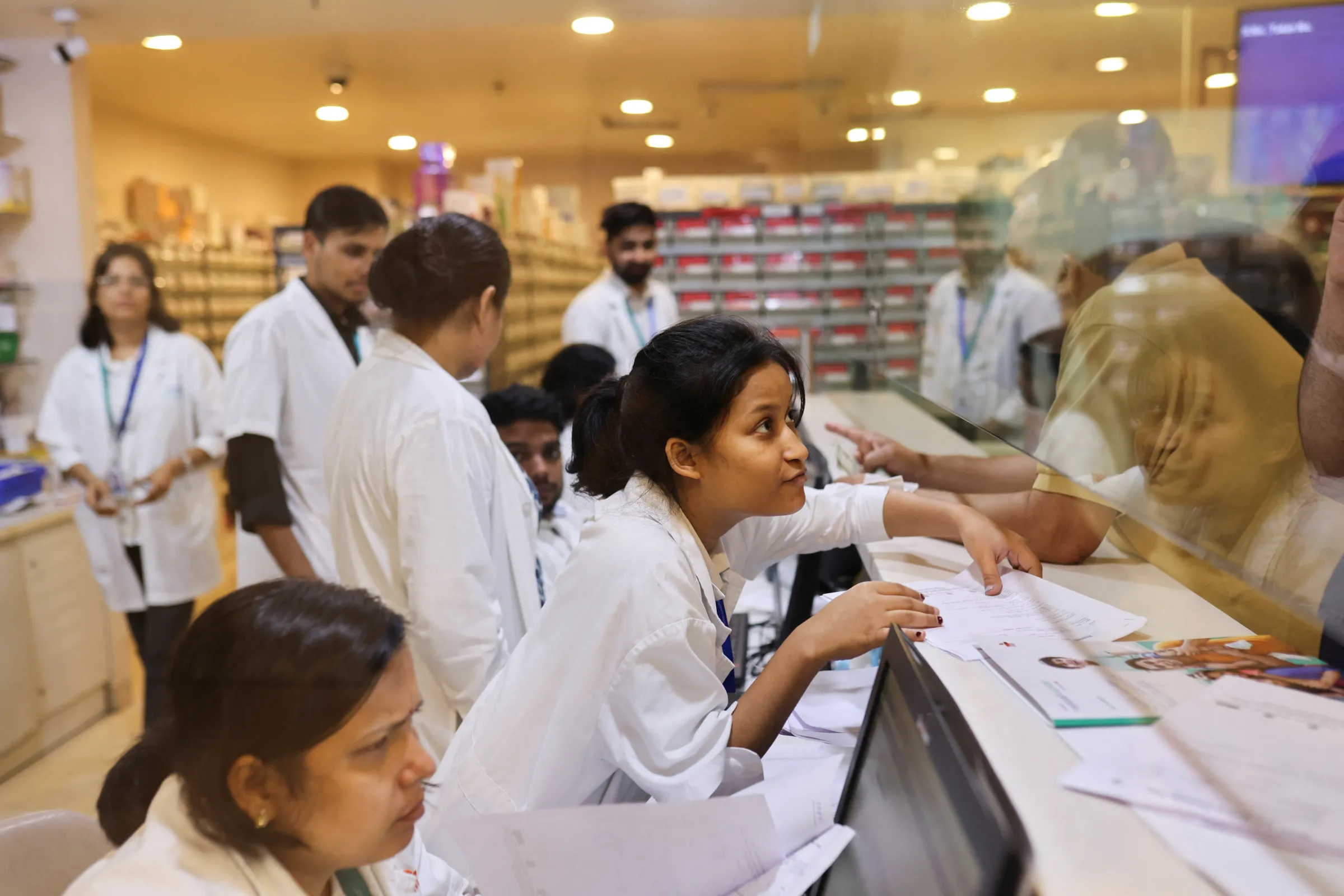 A pharmacist speaks to a patient at the pharmacy at a hospital in New Delhi, India, June 22, 2023. REUTERS/Anushree Fadnavis