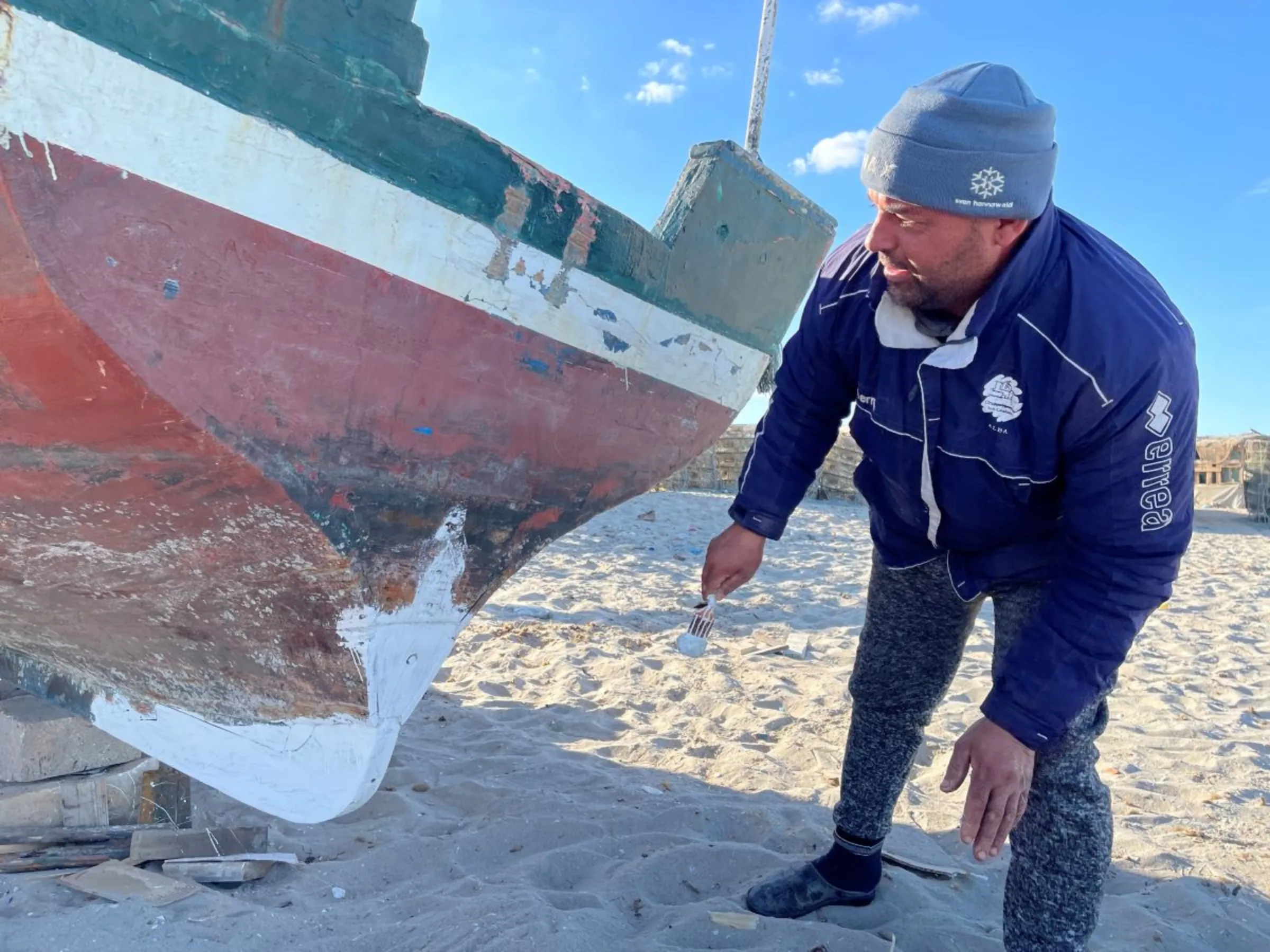 Mohamed Ali, a 39-year-old fisherman, checks his boat in Ghannounch, Gabes, southern Tunisia on February 1, 2022. Thomson Reuters Foundation/Menna A. Farouk