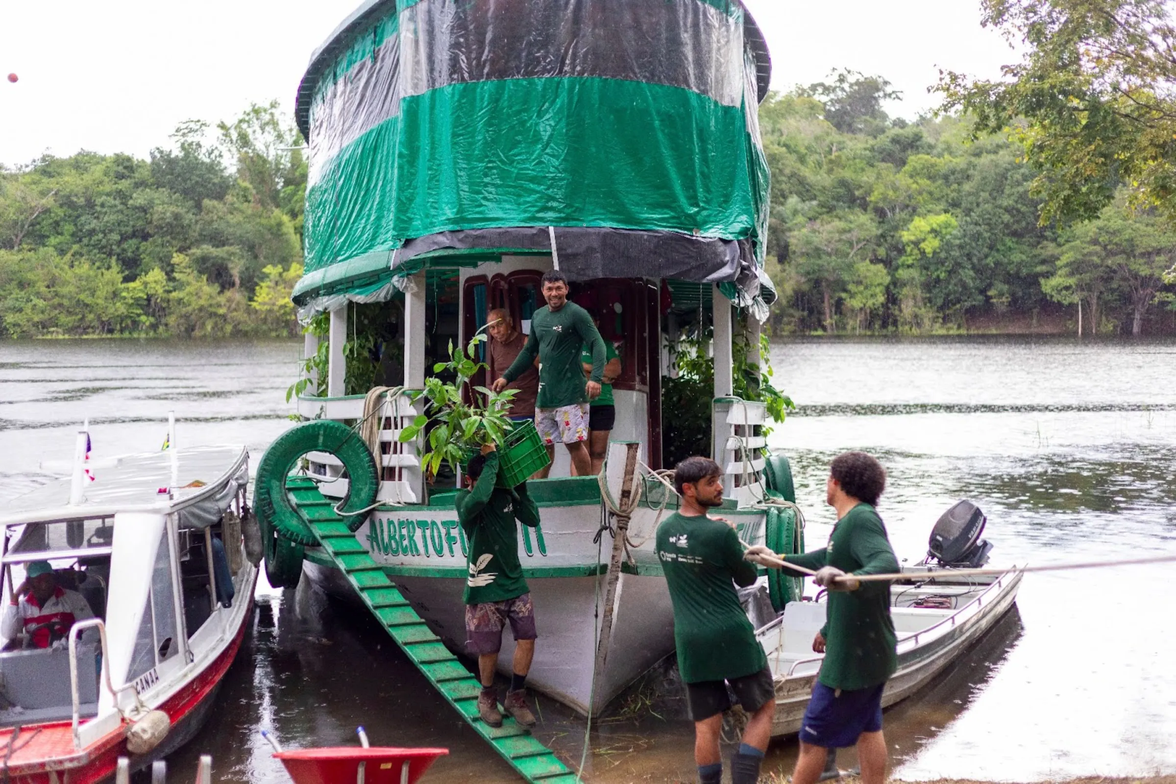 Agents from a reforestation project from NGO IPÊ disembark with tree seedlings in RDS Puranga Conquista, Manaus, Brazil, March 13, 2025. Nathalie Brasil/Thomson Reuters Foundation