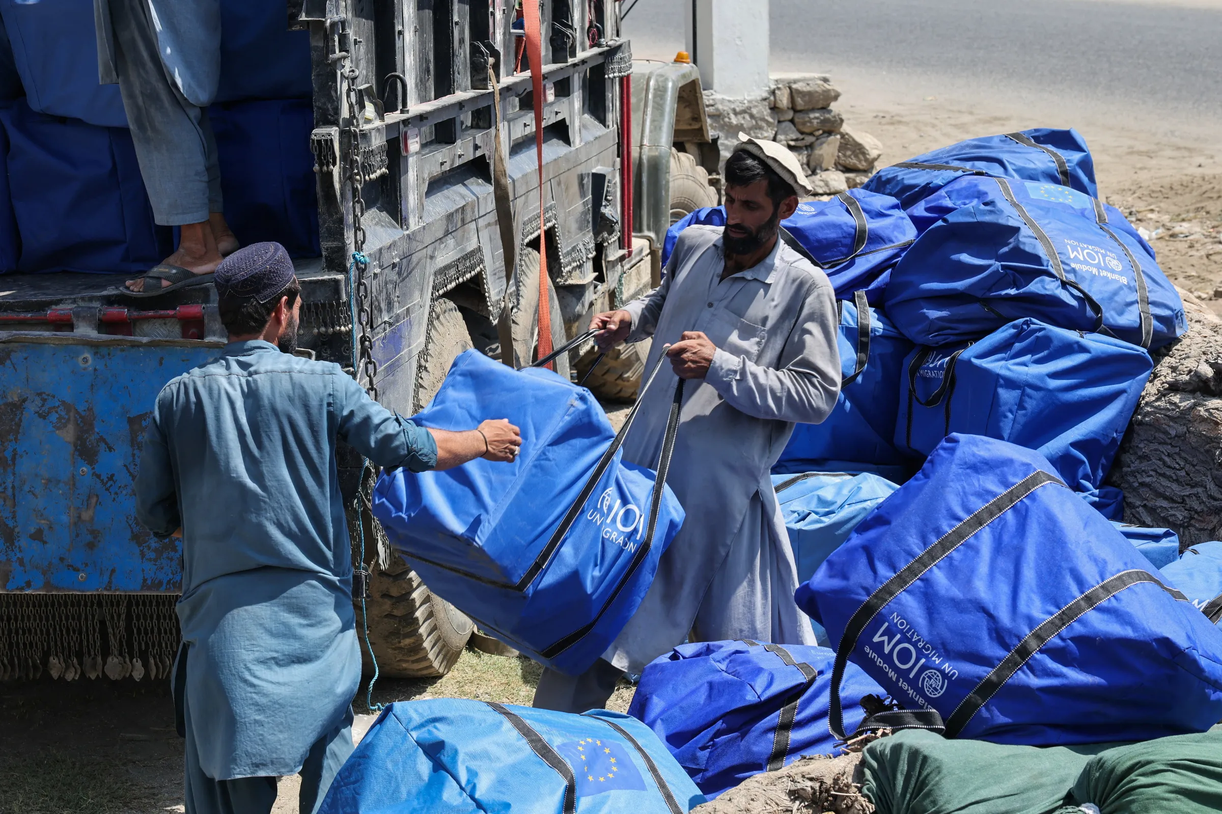 Workers load supplies onto a truck for earthquake victims in Nurgal district, Kunar province in Afghanistan September 6, 2025. REUTERS/Sayed Hassib