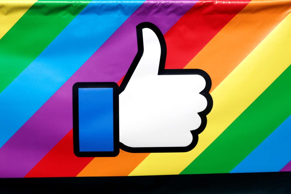 A thumbs up logo is displayed on a rainbow banner