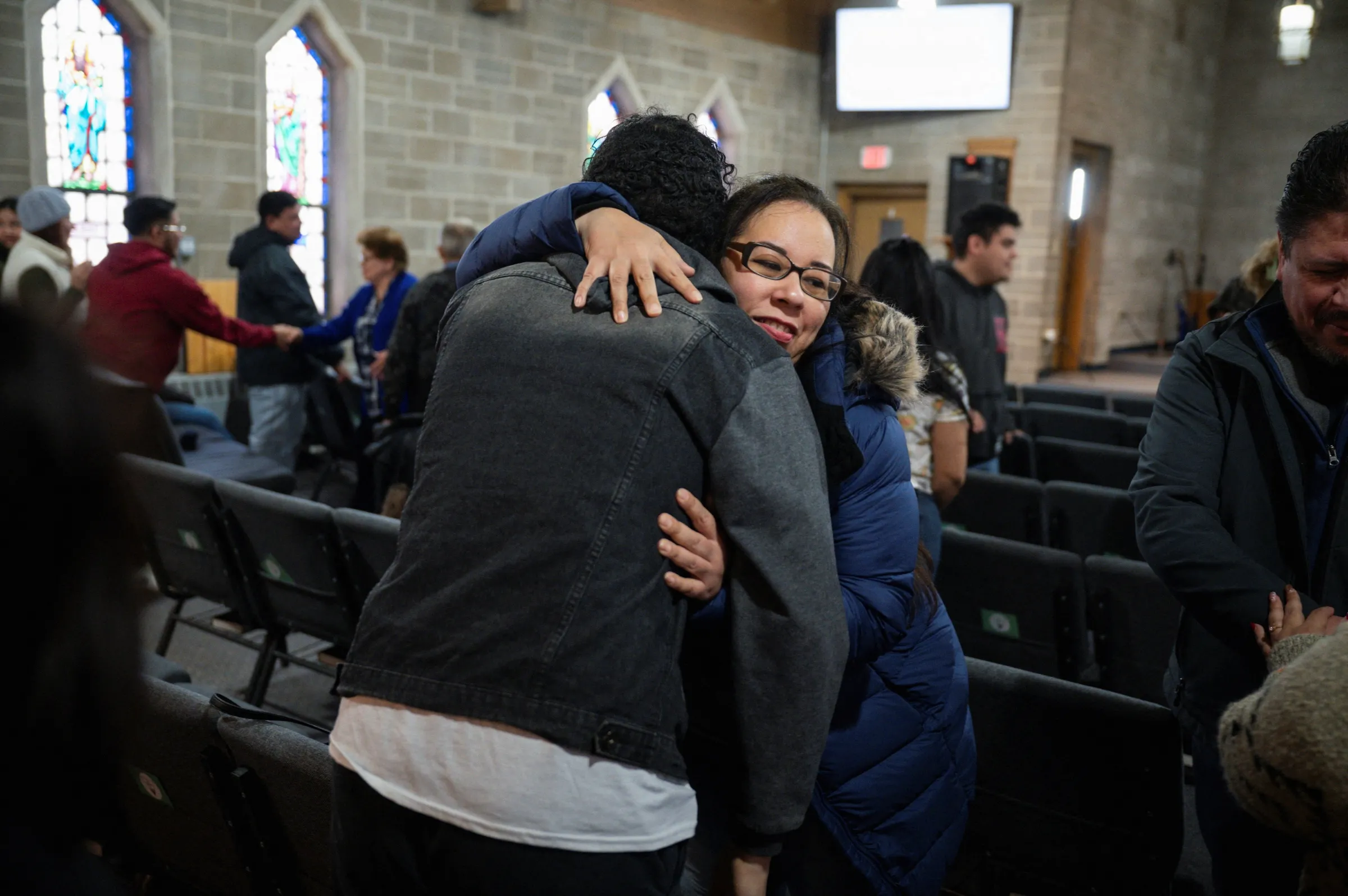 People embrace during a service at Starting Point Community Church, amid concerns of intensified immigration enforcement by U.S. Immigration and Customs Enforcement (ICE) in Chicago, Illinois U.S. January 26, 2025. REUTERS/Vincent Alban
