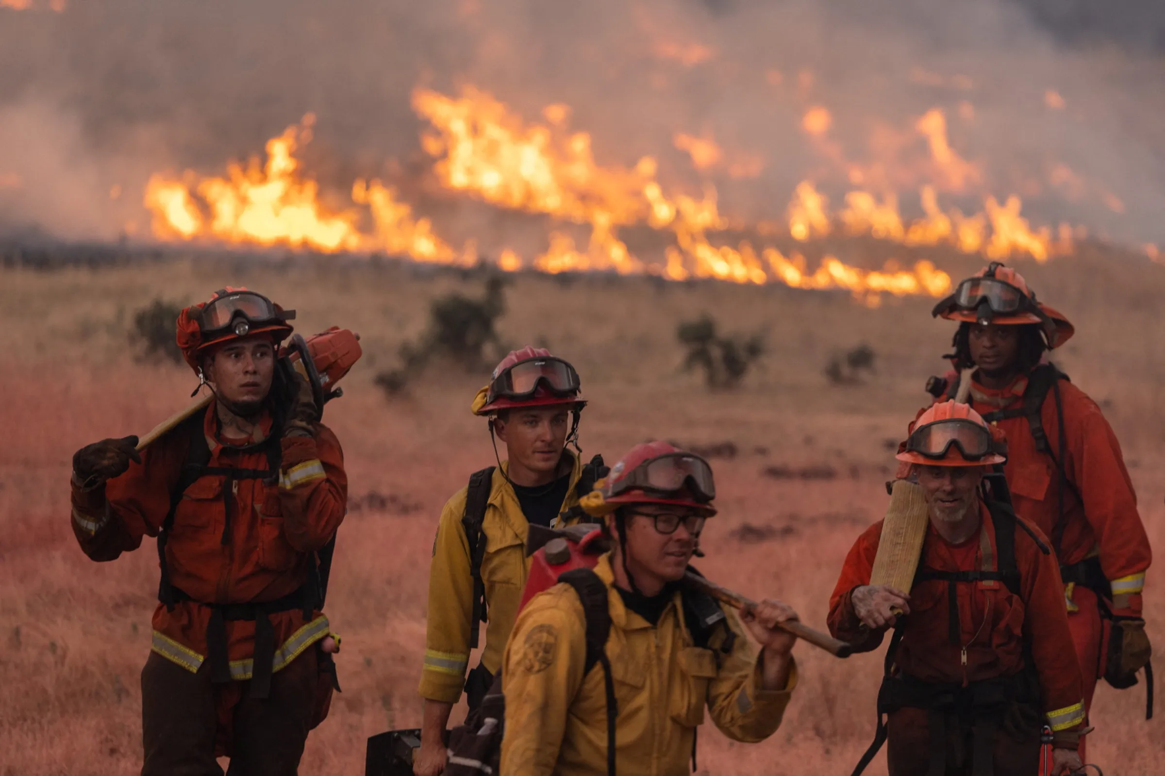 Firefighters battle the Thompson wildfire in a canyon near Oroville, California, U.S., July 2, 2024. REUTERS/Carlos Barria