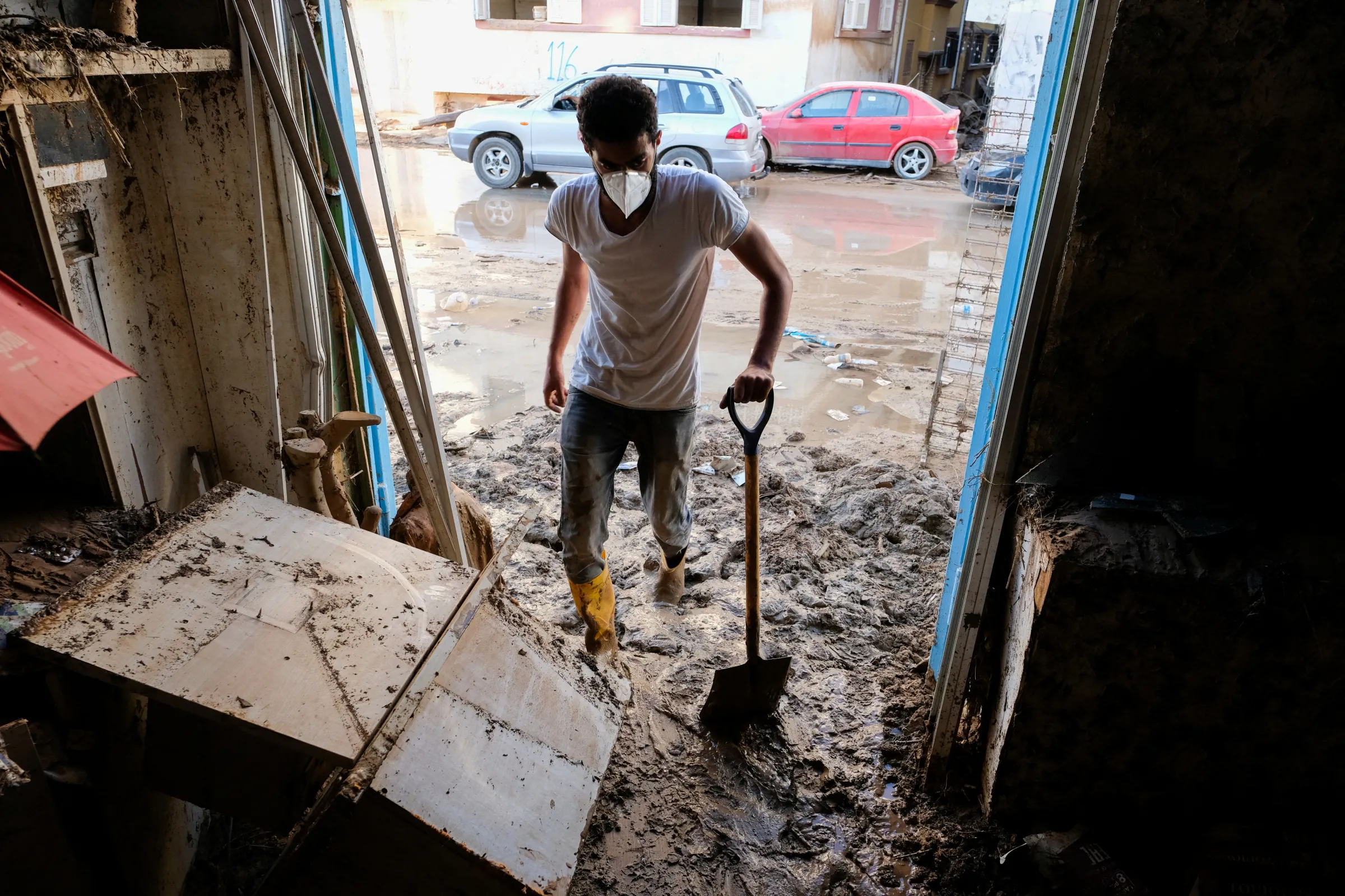 A man clears mud covering the floor of his pharmacy, which was affected by fatal floods, in Derna, Libya, September 28, 2023. REUTERS/Esam Omran Al-Fetori