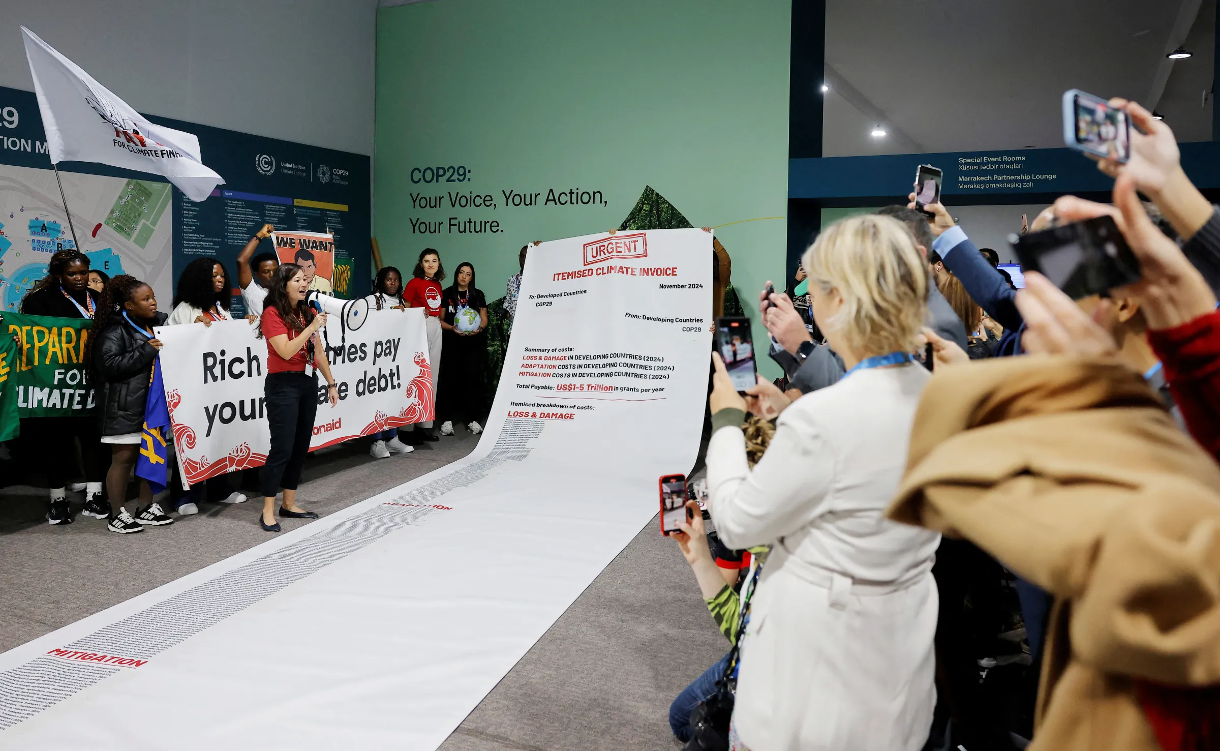 Activists display a 10 metre long climate invoice directed at developed countries at a protest during the United Nations Climate Change Conference (COP29), in Baku, Azerbaijan November 14, 2024. REUTERS/Maxim Shemetov