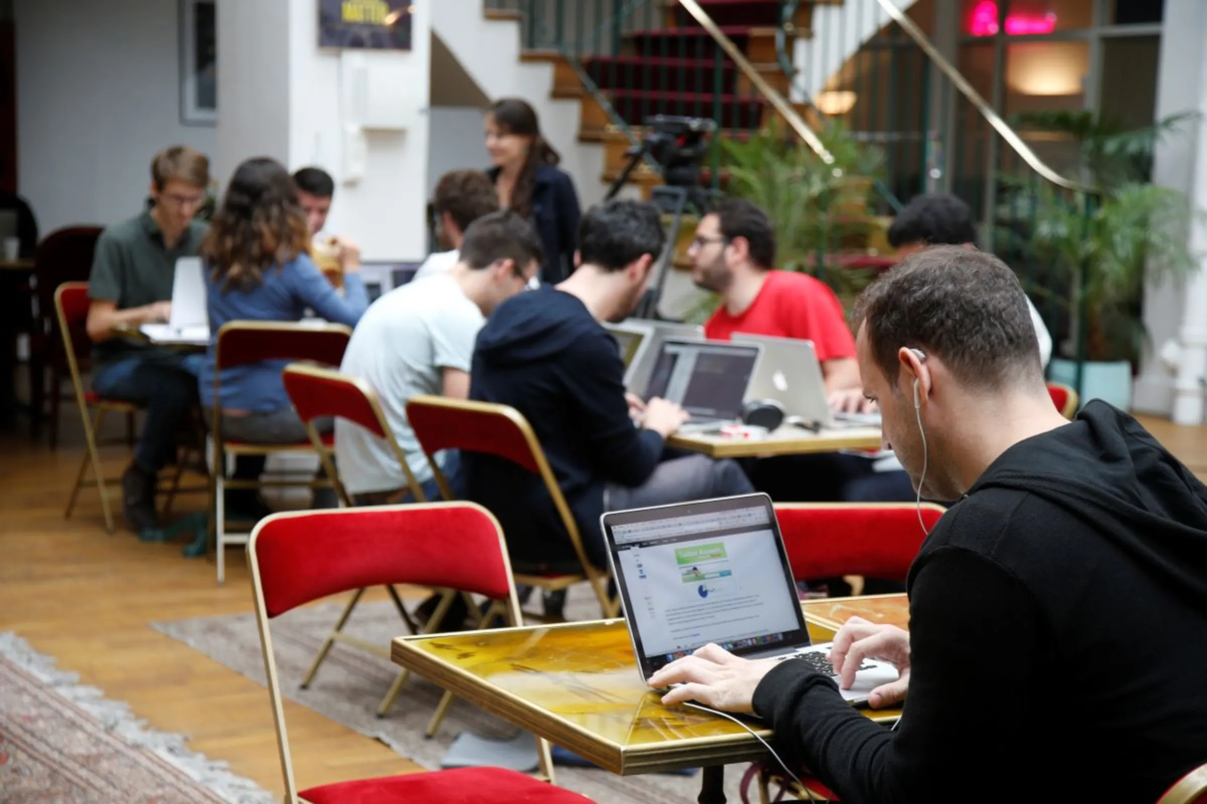 Entrepreneurs work at their computer laptops at 'TheFamily' in Paris, France, July 27, 2015. REUTERS/Charles Platiau