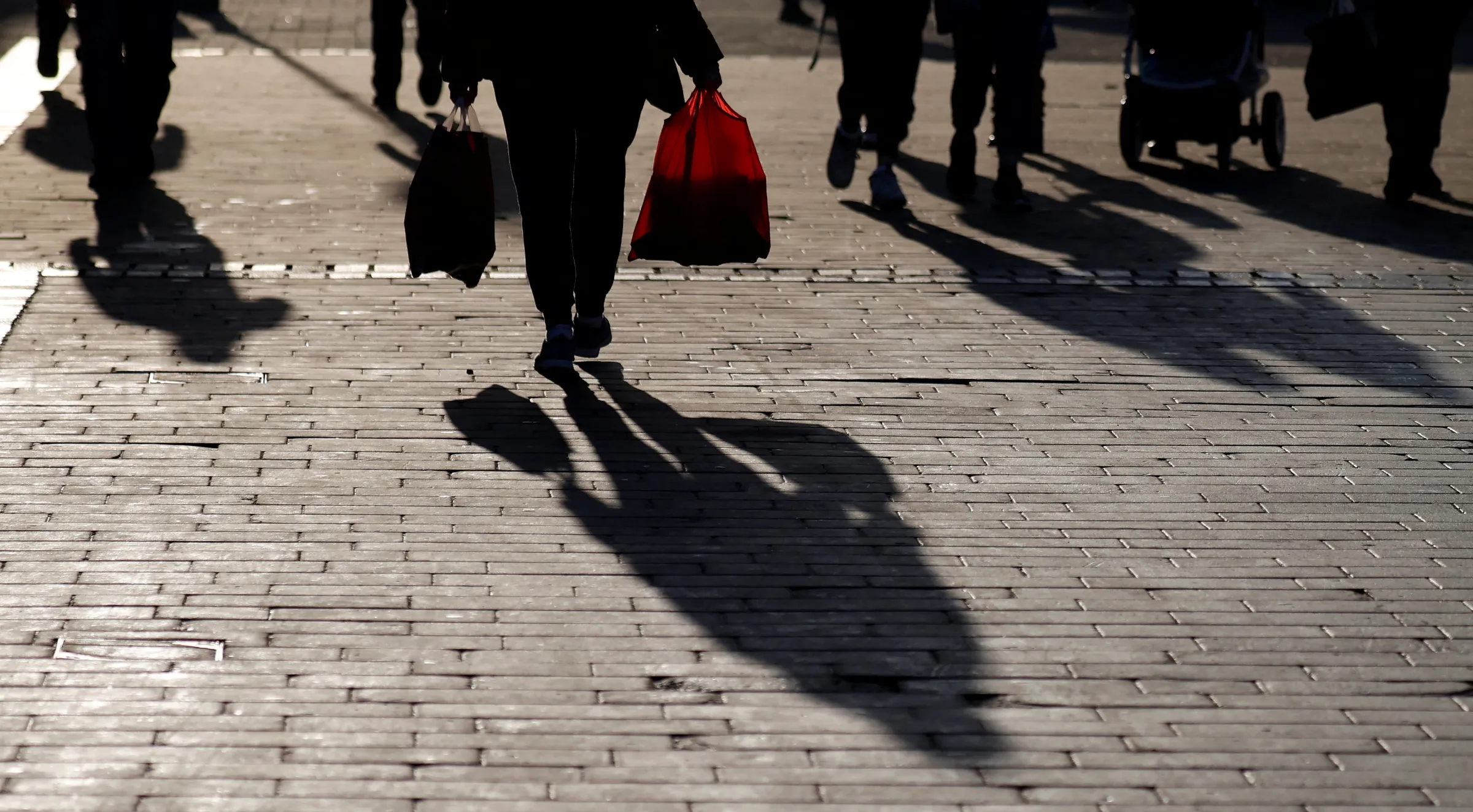 A woman carries shopping bags as she walks along a pedestrianised street, amid the coronavirus disease (COVID-19) pandemic, in Bolton, Britain, December 18, 2021. REUTERS/Phil Noble