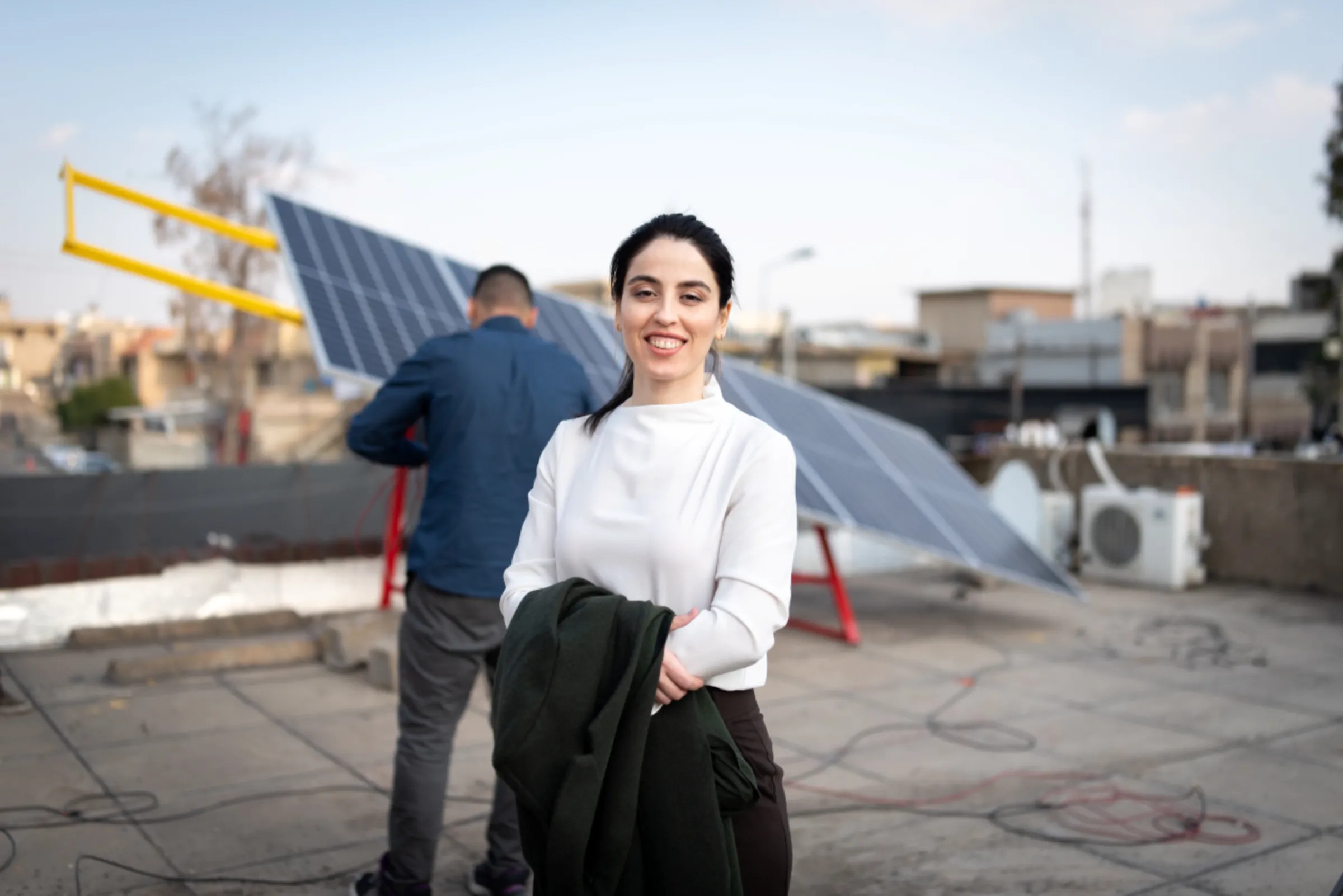 Basima Abdulrahman, founder and CEO of Kesk, poses for a photo in front of a solar panel in this undated handout CWI2021/Handout via Thomson Reuters Foundation