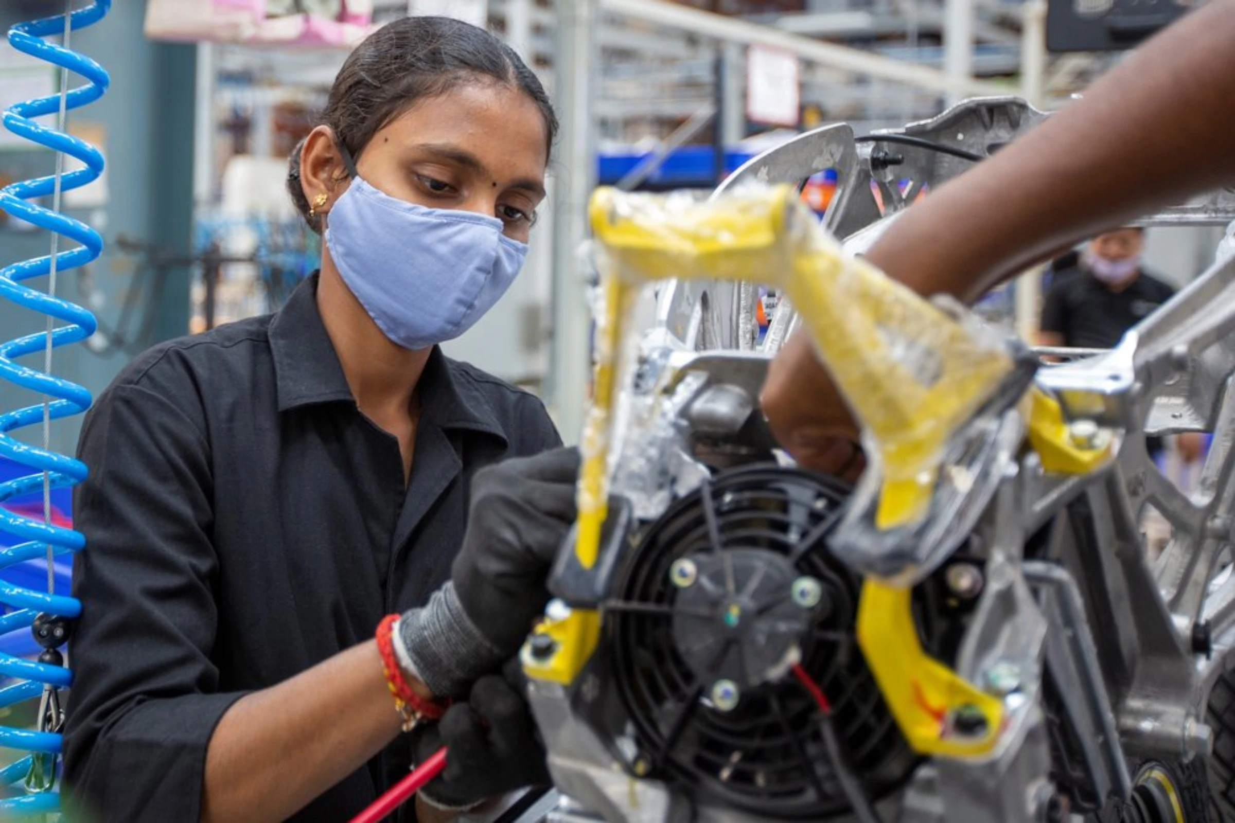 Workers assemble electric scooters at the Ather Energy factory in Hosur, India, April 20, 2022