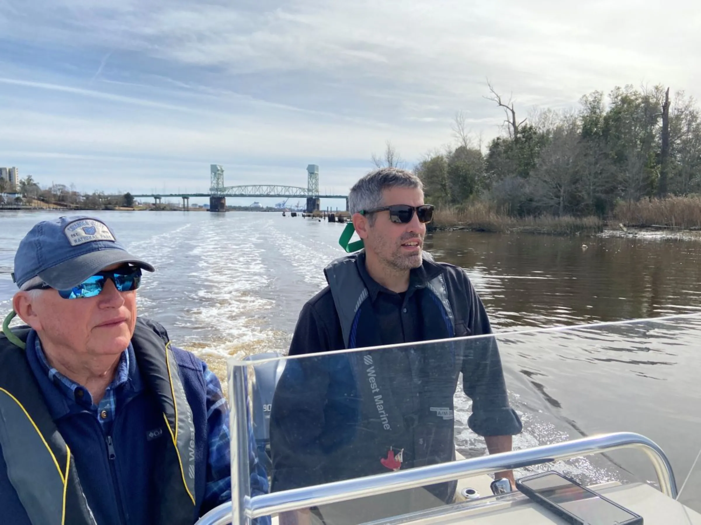 Robert Parr, former oceanographer (left), and Kemp Burdette with Cape Fear River Watch (right) are pictured on the Cape Fear River near downtown Wilmington, North Carolina, USA, February 29, 2024. Thomson Reuters Foundation/David Sherfinski
