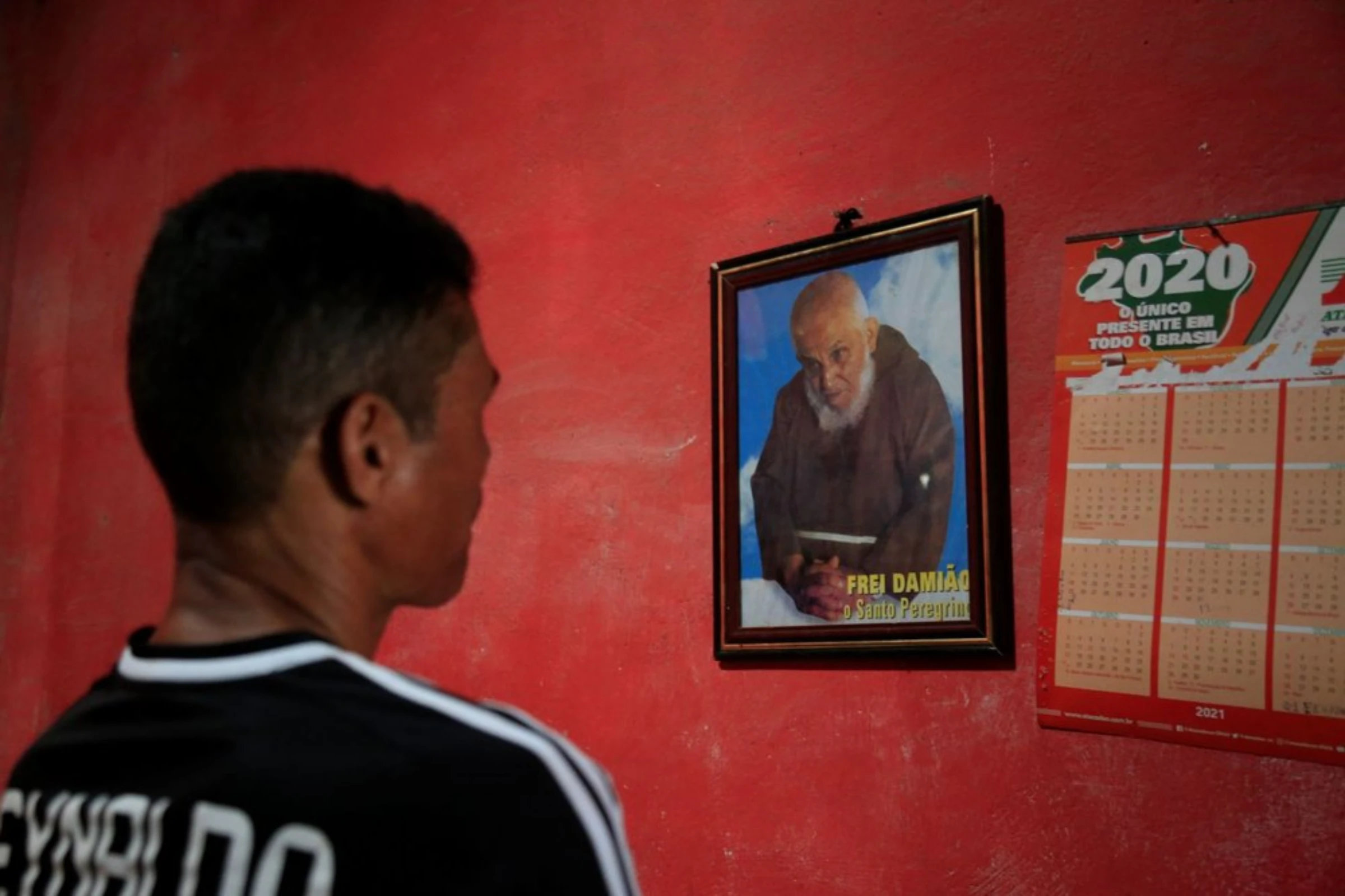 Pedro, a sugarcane worker, looks to saints for protection before he goest to work in Atalaia, Brazil, September 26, 2021