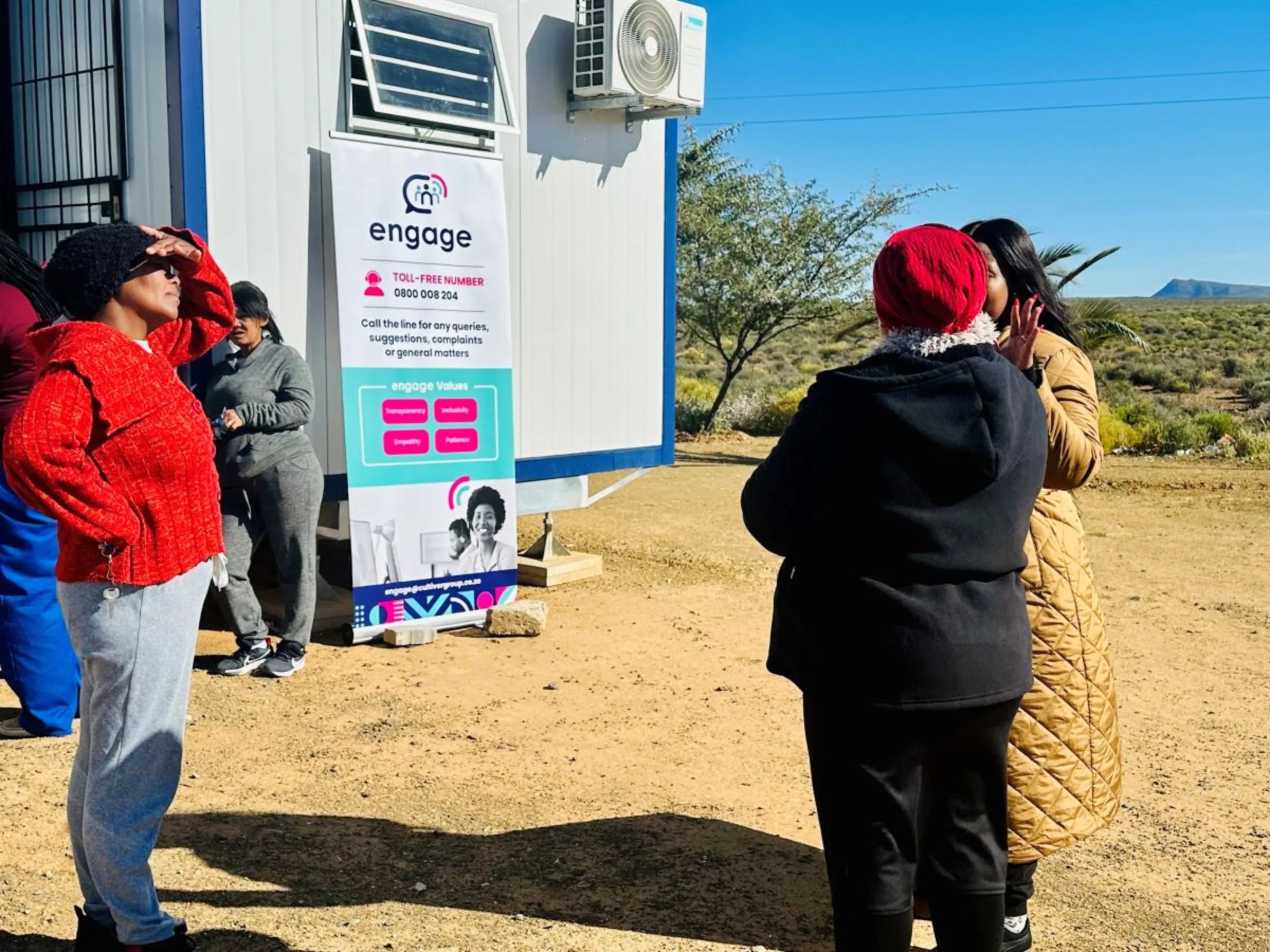 People from the community talk with Fezeka Stuurman, head of Cultiver, in Matjiesfontein, South Africa, May 2024. Cultiver/Handout via Thomson Reuters Foundation